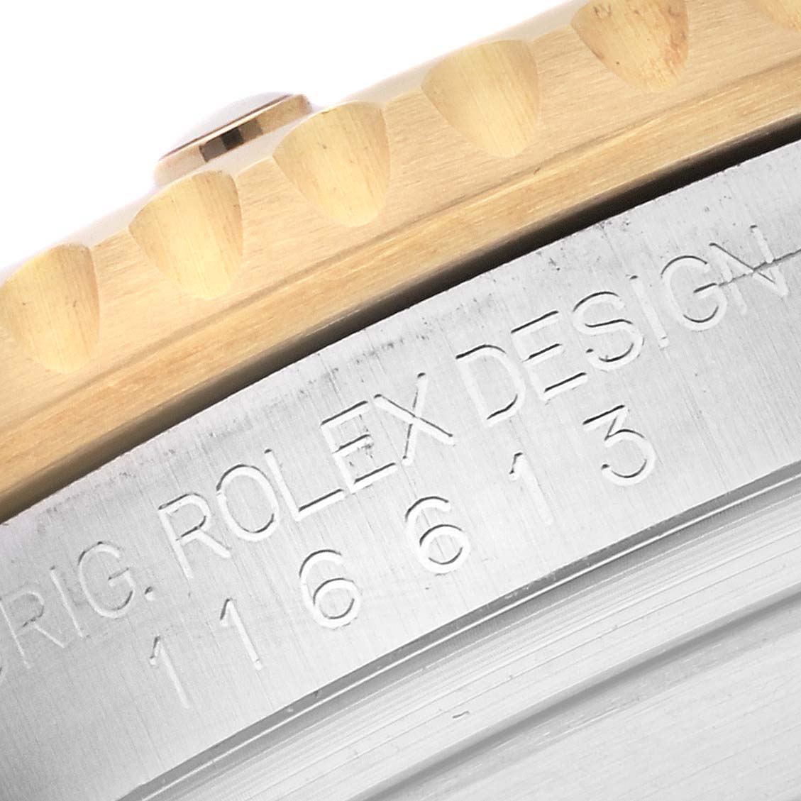 The image shows a close-up angle of the bezel and engraving on a Rolex Submariner 116613 Men's Steel and Gold (two tone) Black Dial 116613 Men's Steel and Gold (two tone) Black Dial watch.