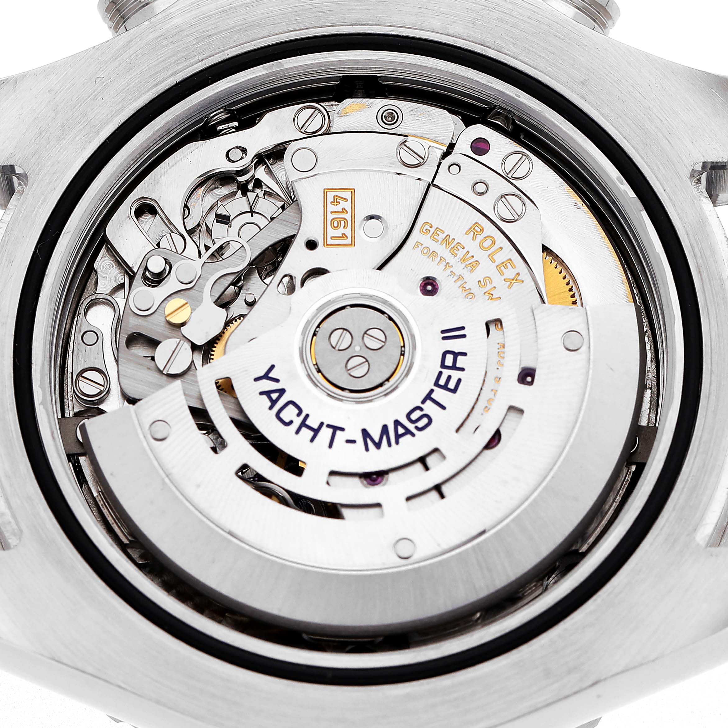 The image shows the movement of a Rolex Yacht-Master 116680 Men's Stainless Steel White Dial watch from a back angle, highlighting its intricate inner mechanisms.