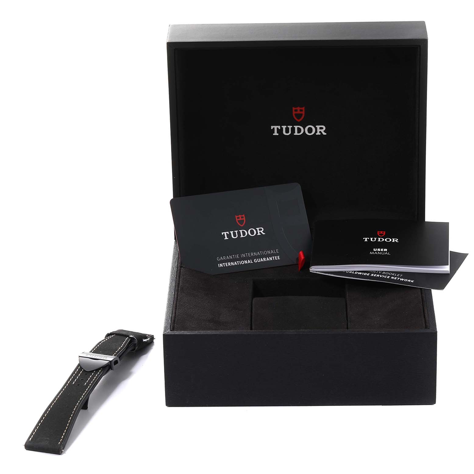 The image shows the packaging and accessories of a Tudor Heritage Black Bay 79210CNU Men's Ceramic Black Dial 79210CNU Men's Ceramic Black Dial watch, including manuals, a guarantee card, and an extra strap.