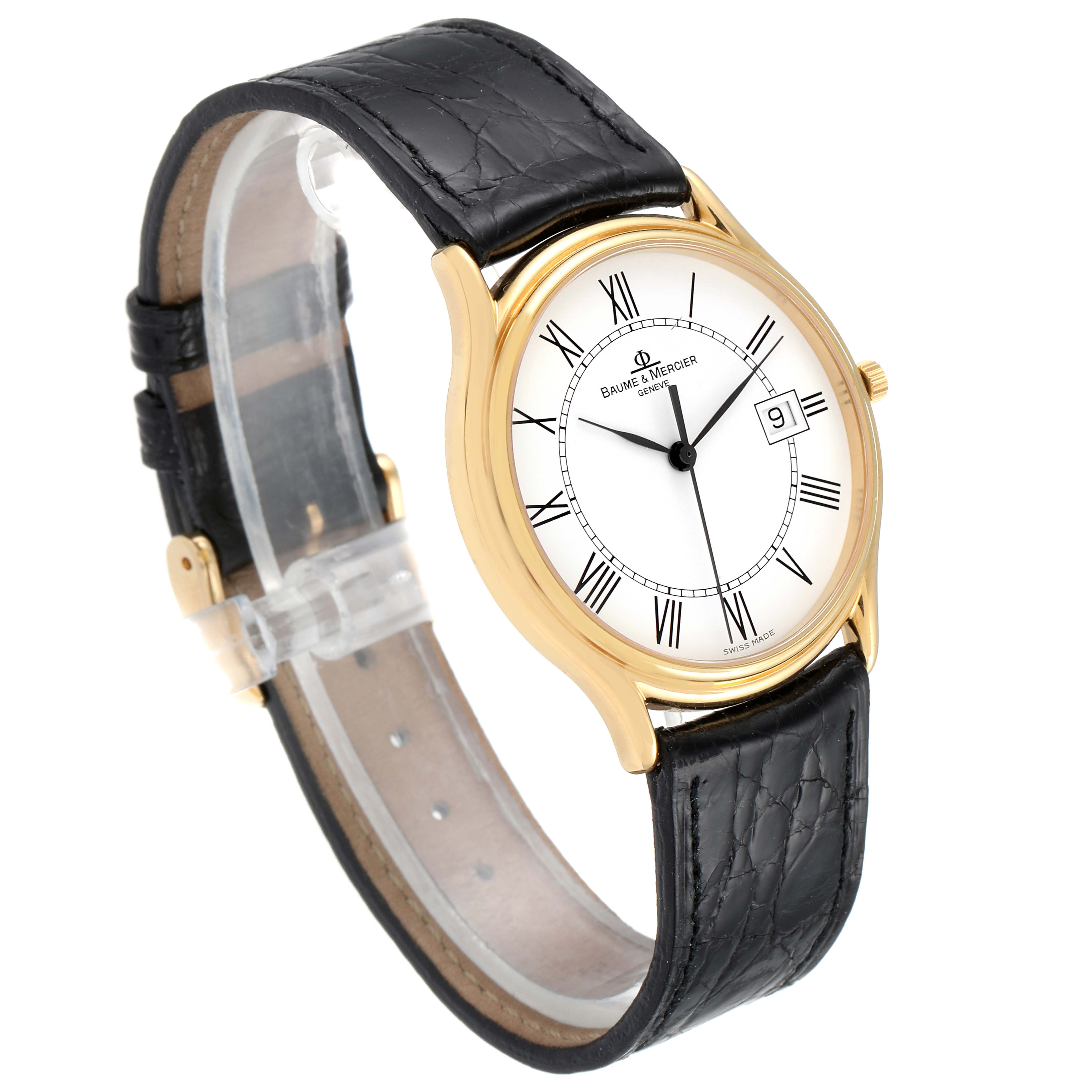 The Baume & Mercier Classima MV045236 Men's Yellow Gold White Dial MV045236 Men's Yellow Gold White Dial watch is shown at a slight angle, highlighting the gold case, white dial, black leather strap, and date display.