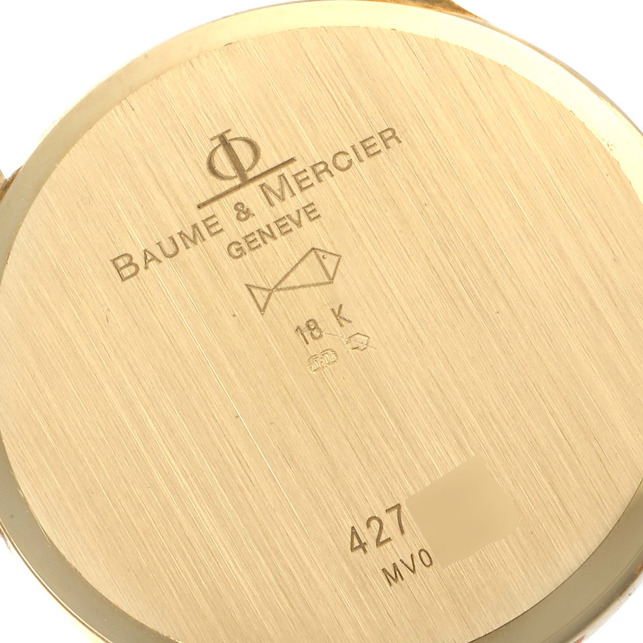 The image shows the back case of the Baume & Mercier Classima MV045236 Men's Yellow Gold White Dial MV045236 Men's Yellow Gold White Dial watch, displaying brand engravings and an 18K gold mark.