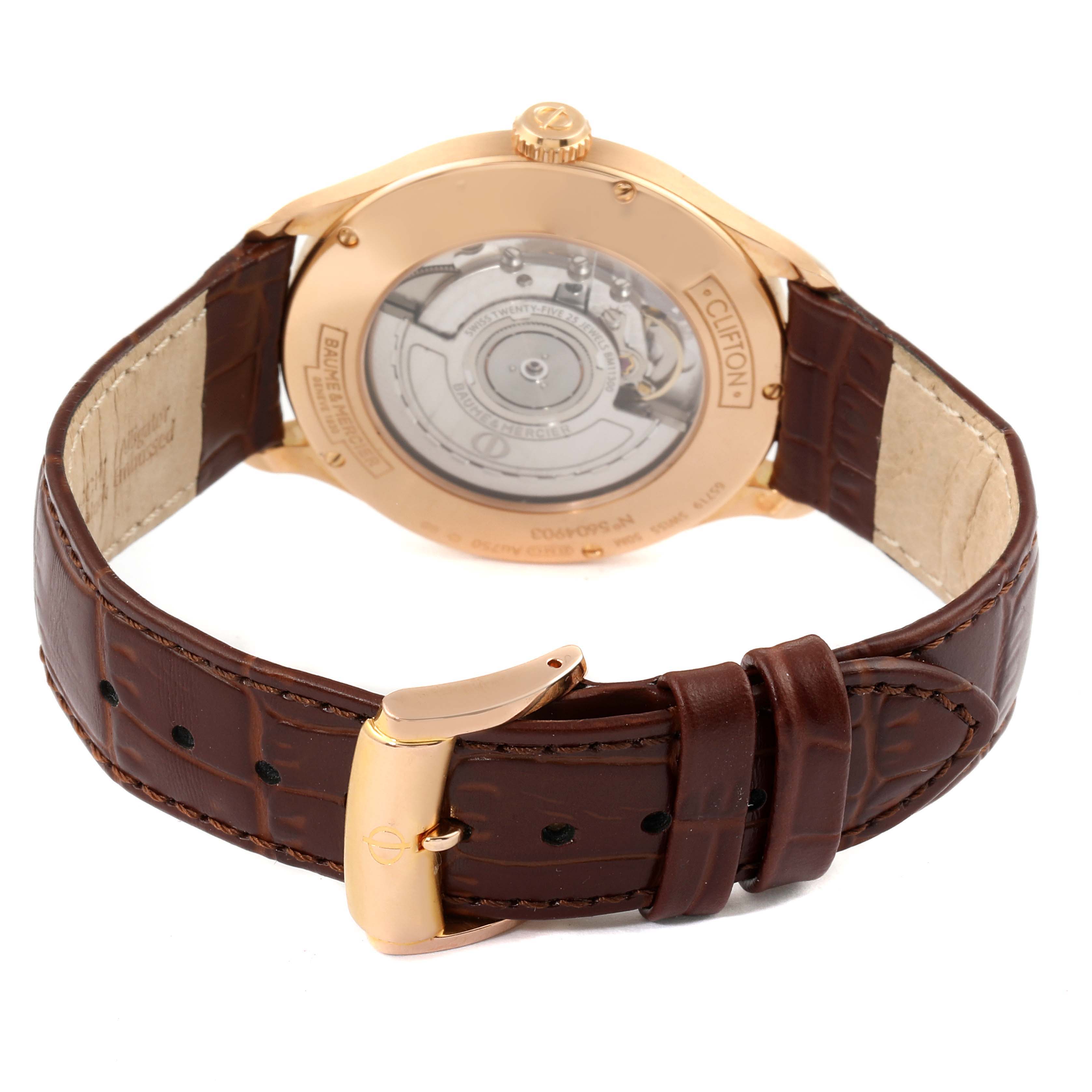 The image shows the back view of a Baume & Mercier Clifton M0A10059 Men's Rose Gold Grey Dial M0A10059 Men's Rose Gold Grey Dial watch, highlighting its movement and leather strap.