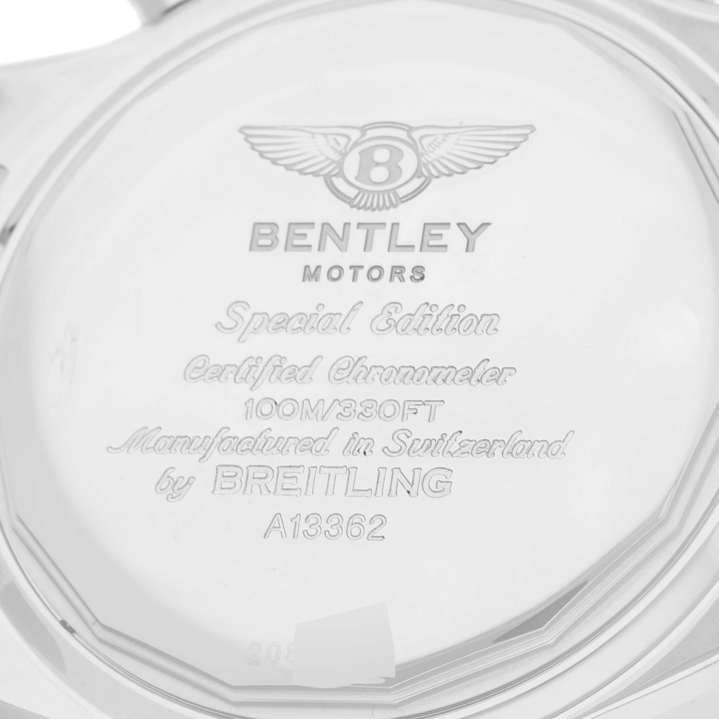 The image shows the back casing of a Bentley model by Breitling, displaying engravings with watch specifications.