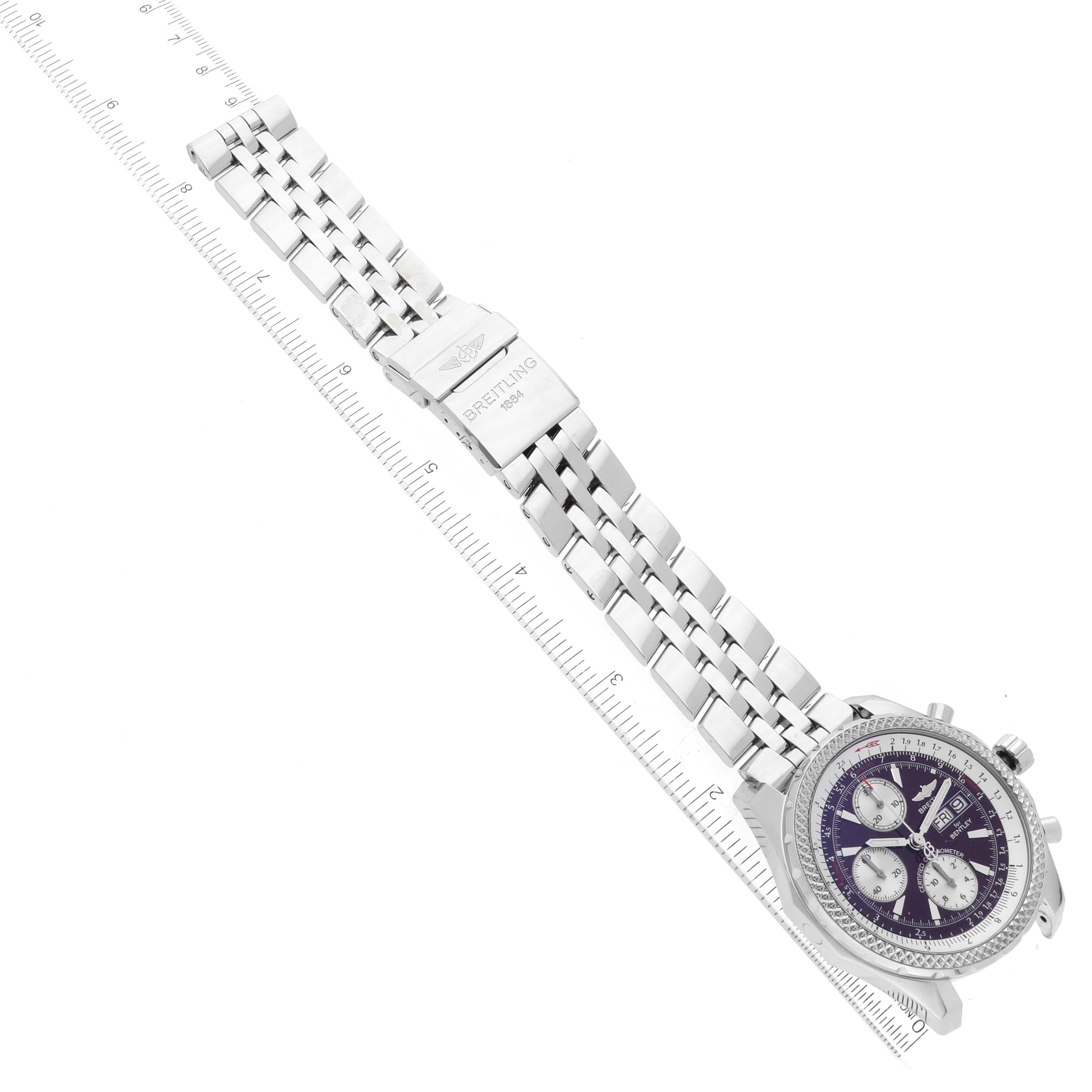 The image shows the Breitling Bentley A13362 Men's Stainless Steel Red Dial A13362 Men's Stainless Steel Red Dial watch angled at a diagonal, displaying the face, bezel, and metal bracelet with a ruler for scale.