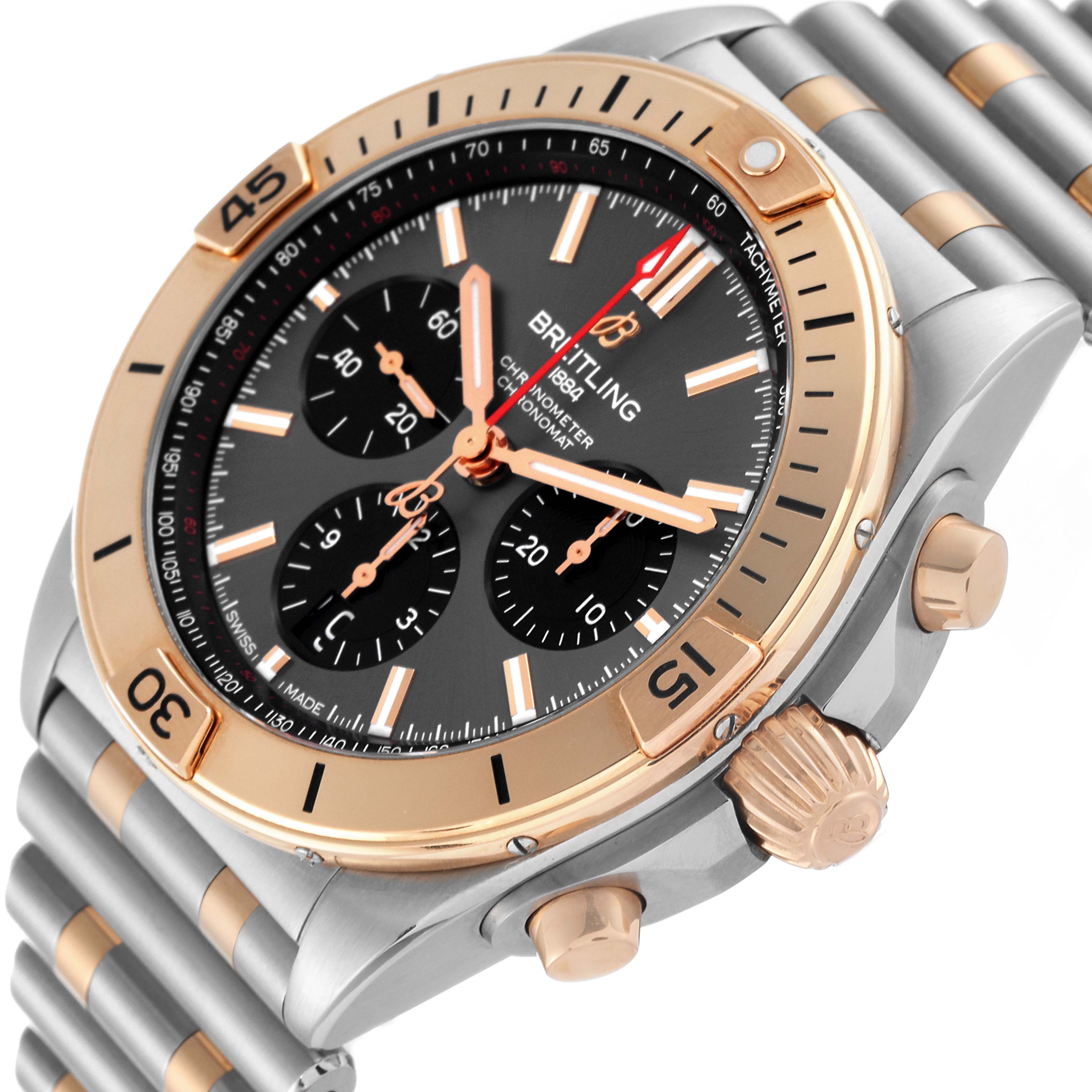 The image shows a close-up of the Breitling Chronomat UB0134 Men's Steel and Gold (two tone) Grey Dial UB0134 Men's Steel and Gold (two tone) Grey Dial watch, highlighting its bezel, dial, and part of the bracelet.