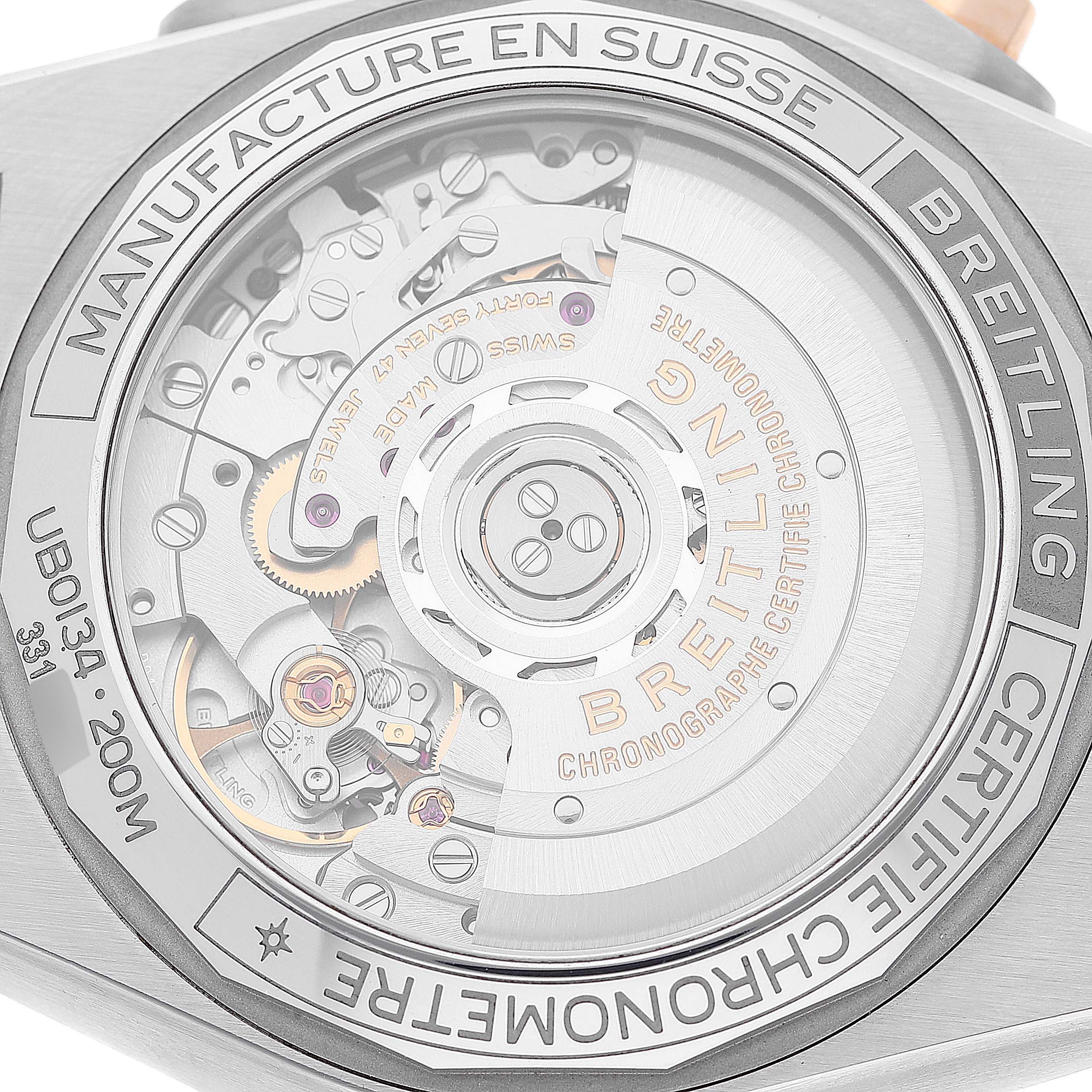 The image shows the back angle of the Breitling Chronomat UB0134 Men's Steel and Gold (two tone) Grey Dial UB0134 Men's Steel and Gold (two tone) Grey Dial watch displaying its mechanical movement and inner workings.