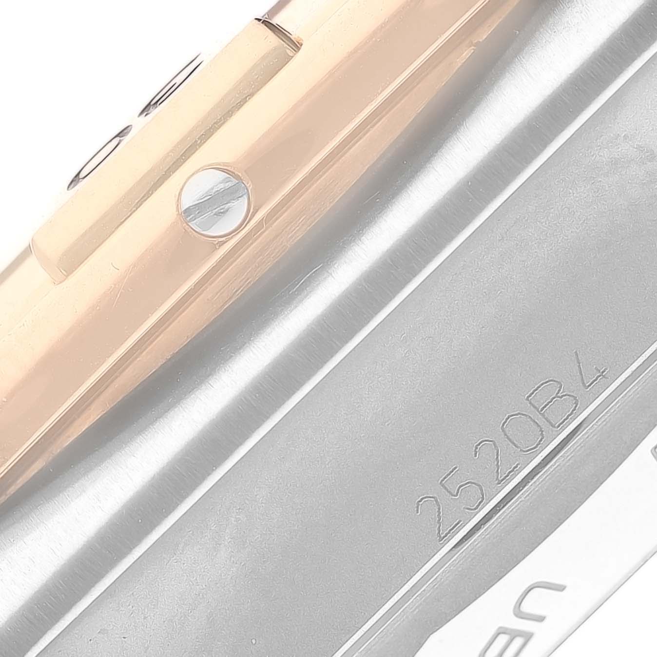 This close-up image of a Breitling Chronomat UB0134 Men's Steel and Gold (two tone) Grey Dial UB0134 Men's Steel and Gold (two tone) Grey Dial watch shows the side view with part of the bezel and a serial number.