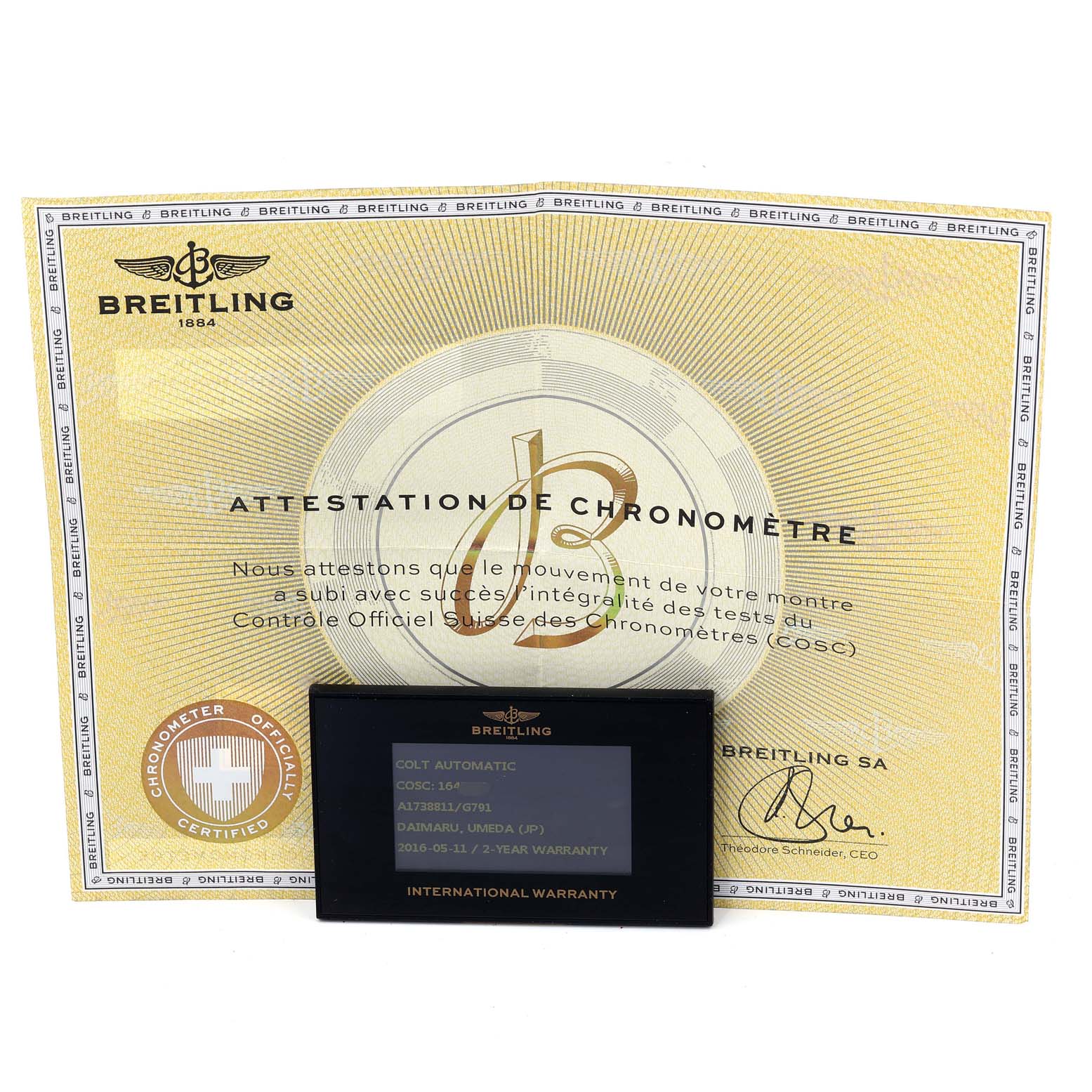 The image shows the Breitling Colt A17388 Men
s Stainless Steel White Dial A17388 Men
s Stainless Steel White Dial model
s certificates and warranty card placed on a flat surface.