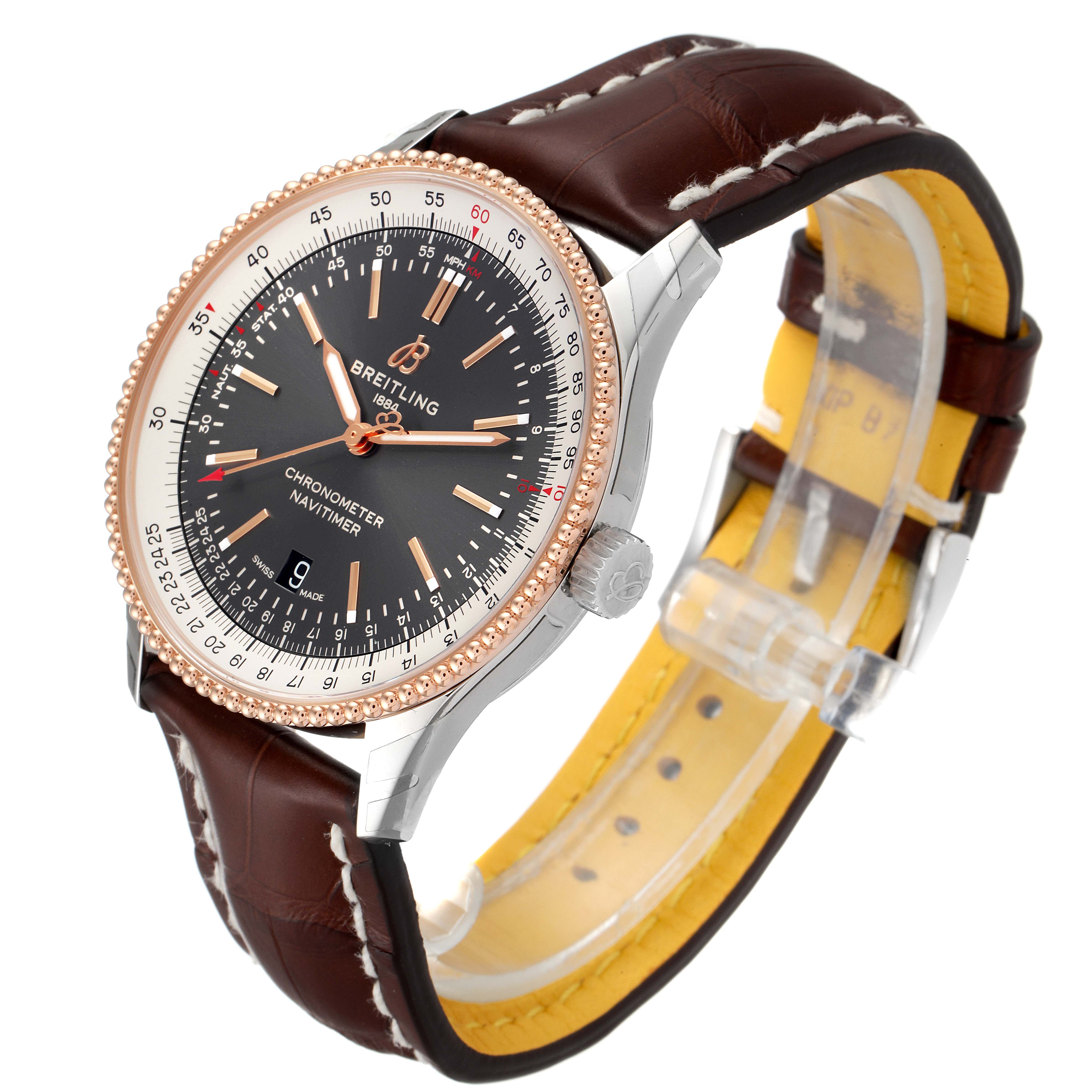 The image shows a side angle of a Breitling Navitimer U17326211M1P1 Men's Steel and Gold (two tone) Grey Dial U17326211M1P1 Men's Steel and Gold (two tone) Grey Dial watch, featuring a brown leather strap and a detailed bezel.