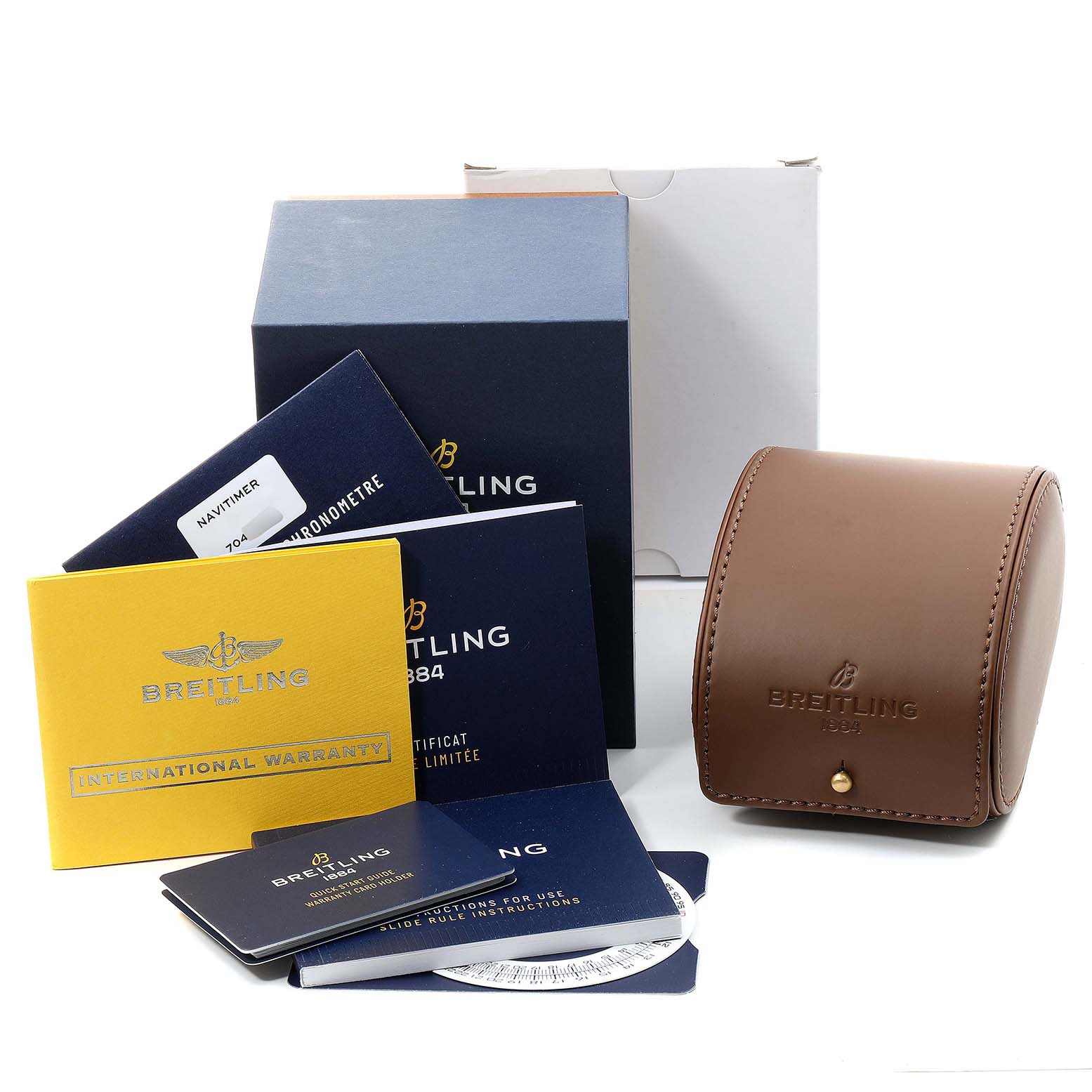 This image shows the accessories and packaging for a Breitling Navitimer U17326211M1P1 Men's Stainless Steel Grey Dial U17326211M1P1 Men's Stainless Steel Grey Dial, including booklets, warranty card, a case, and boxes.