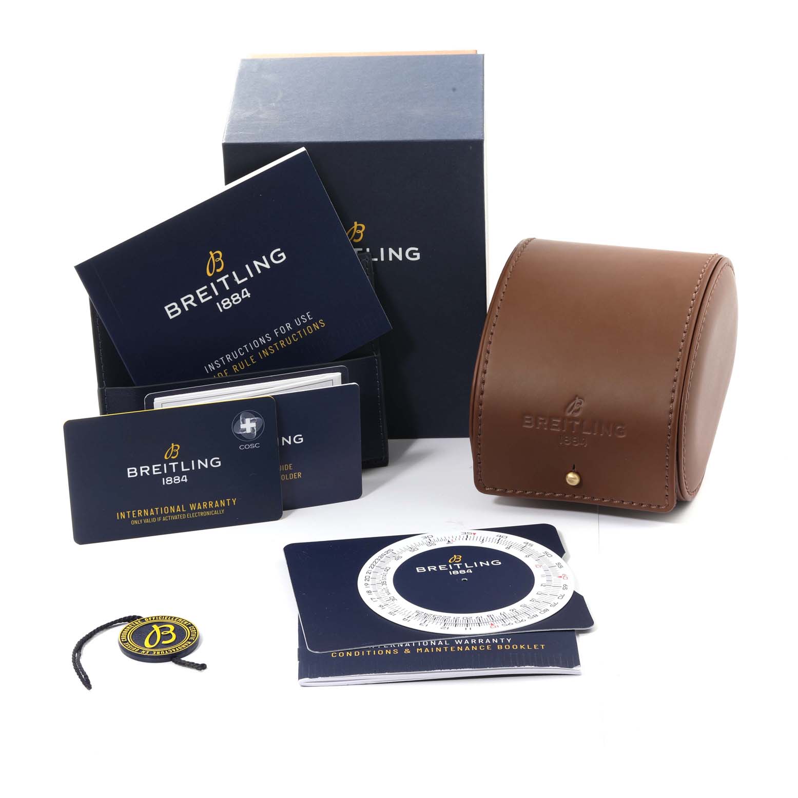 The image shows Breitling Navitimer A24322121B2A1 Men
s Stainless Steel Black Dial A24322121B2A1 Men
s Stainless Steel Black Dial watch accessories including a box, instruction booklets, warranty cards, and a brown leather case.