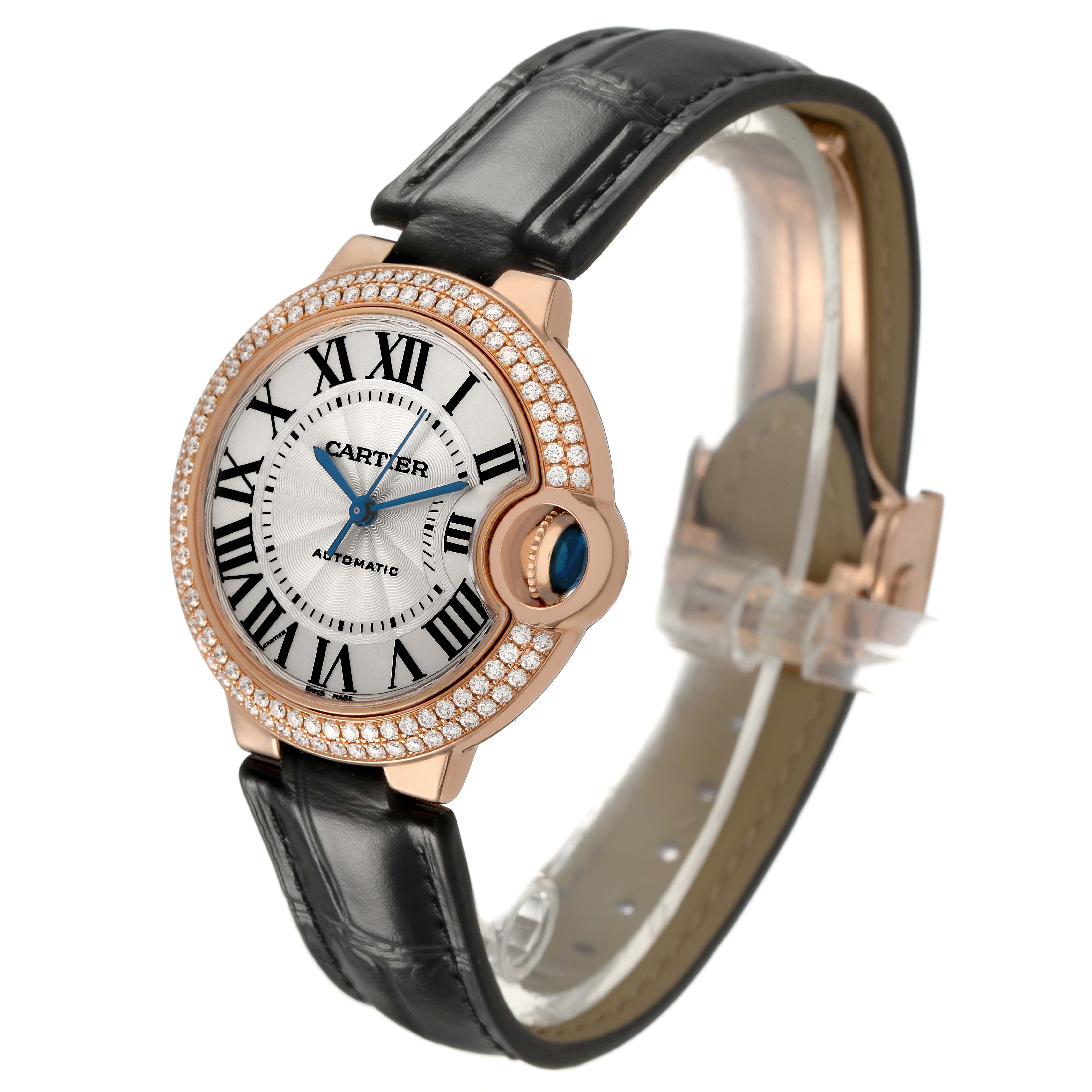 The Ballon Bleu by Cartier is shown at a three-quarter angle, highlighting the diamond bezel, dial, and black leather strap.
