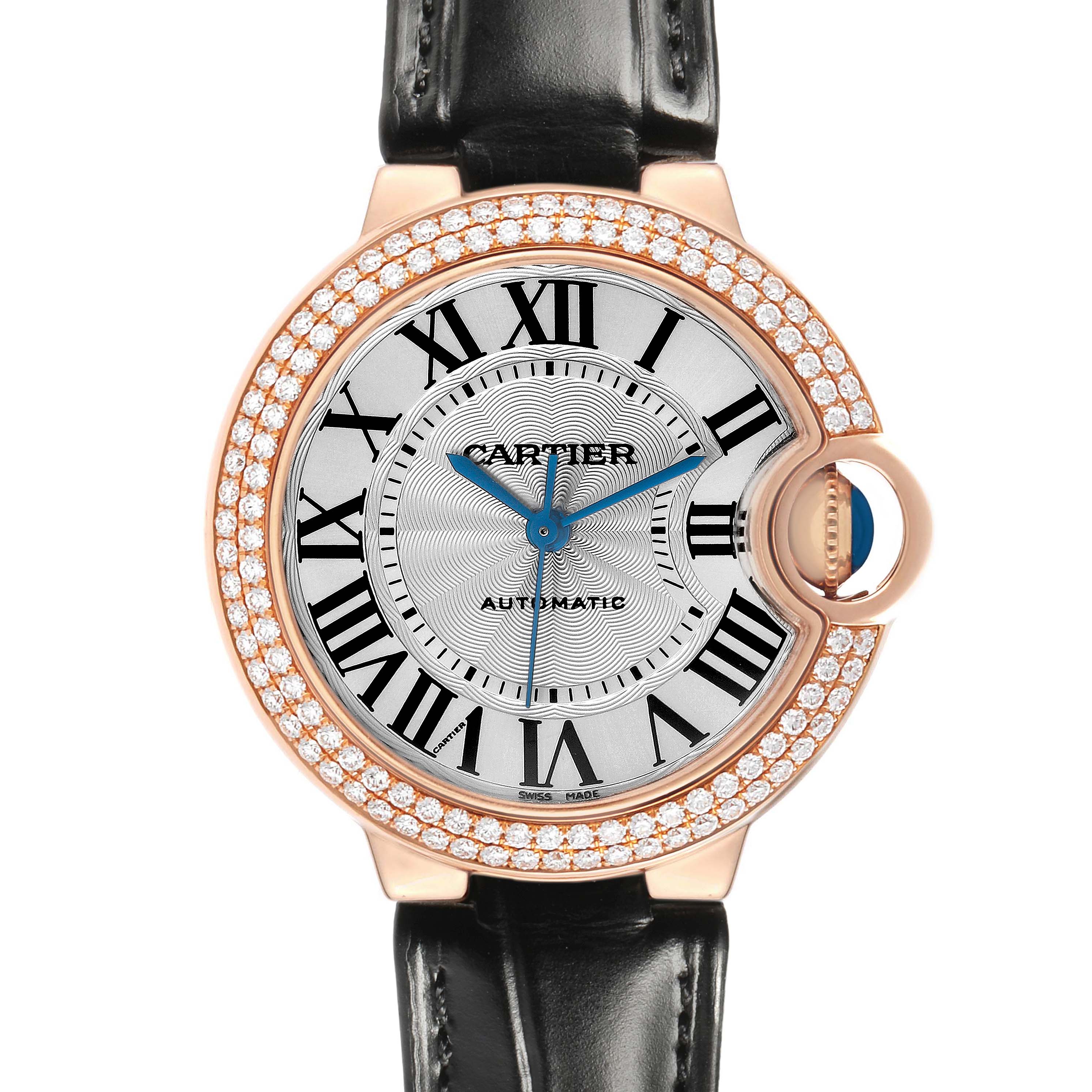 The Cartier Ballon Bleu WE902066 Women's Rose Gold Silver Dial watch is shown front-facing, highlighting its Roman numeral dial, diamond-set bezel, and black leather strap.