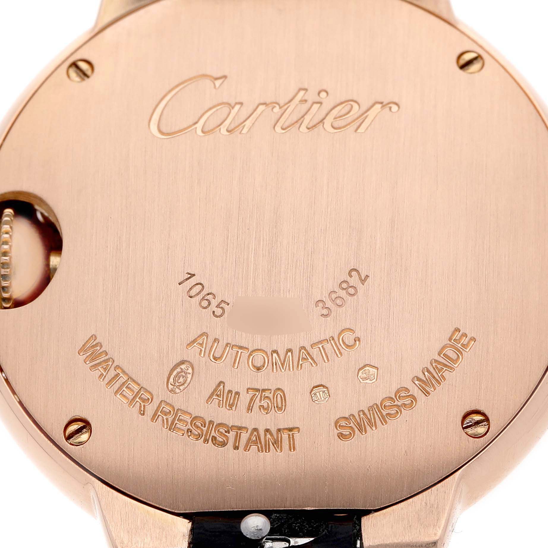 The image shows the back case of a Cartier Ballon Bleu WE902066 Women's Rose Gold Silver Dial watch, highlighting brand engravings and specifications.