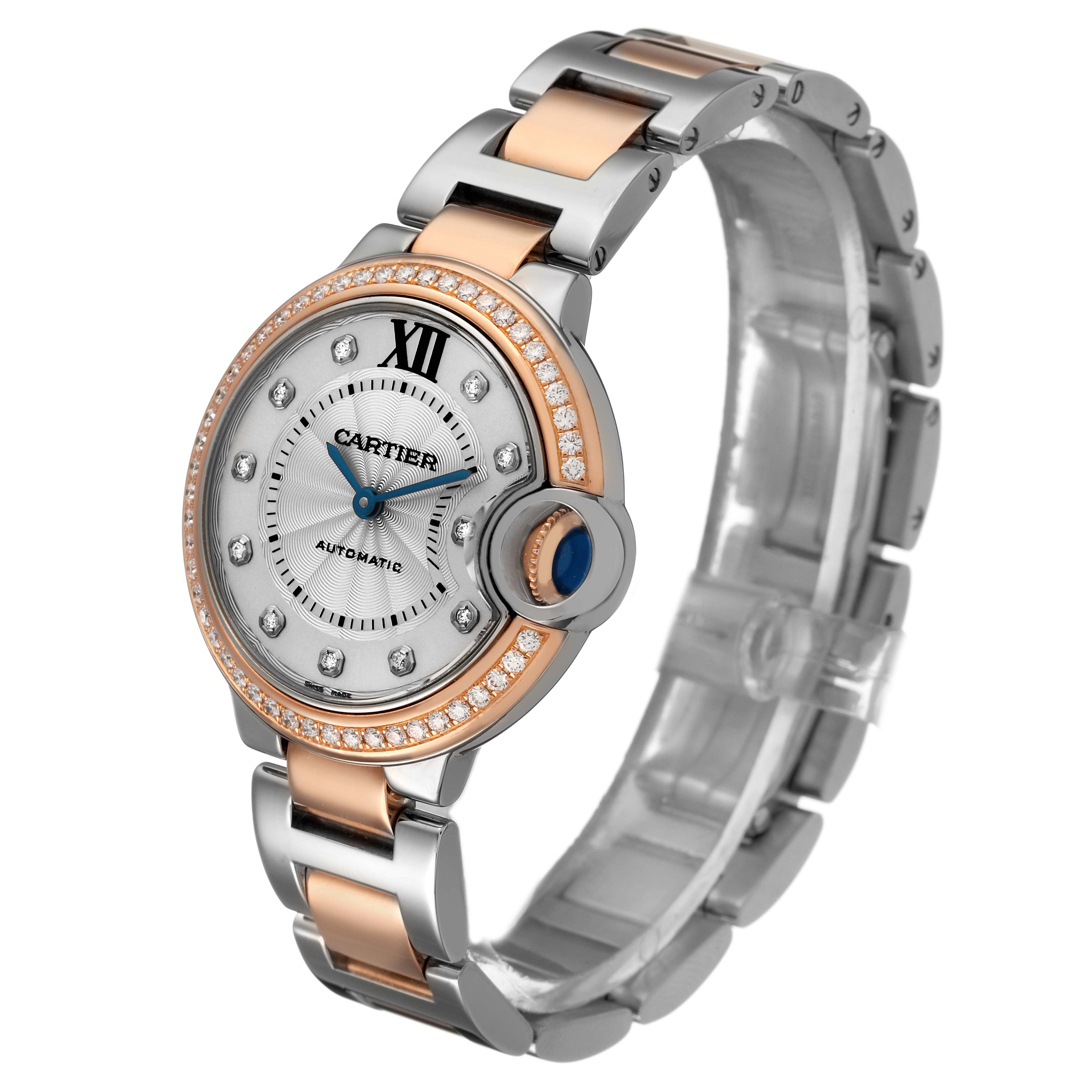 The Cartier Ballon Bleu WE902077 Women's Steel and Gold (two tone) Silver Dial watch is shown at an angle highlighting its two-tone bracelet and diamond-studded bezel.