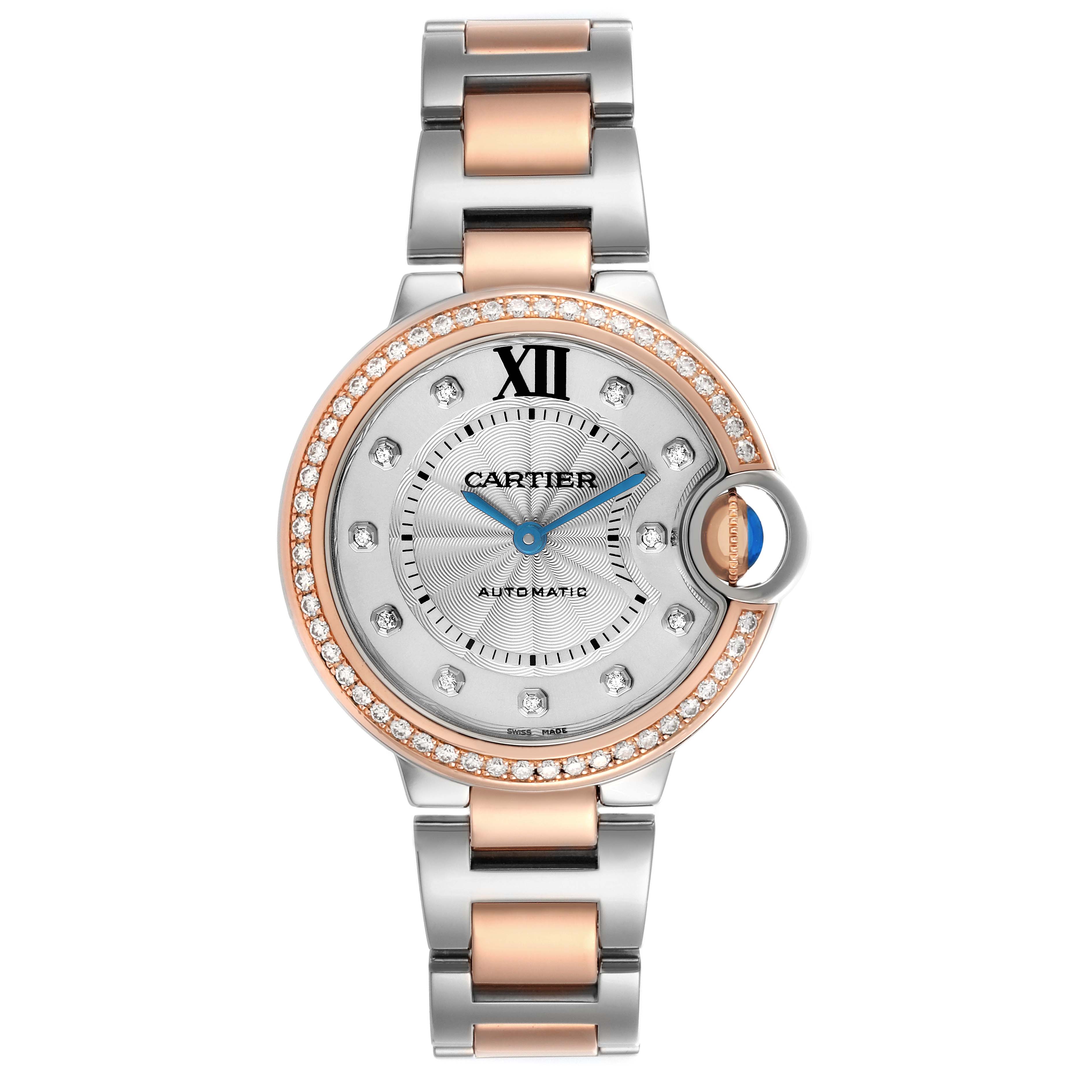 The Cartier Ballon Bleu WE902077 Women's Steel and Gold (two tone) Silver Dial watch is shown from a top-down angle, highlighting its diamond bezel, silver dial, and two-tone bracelet.
