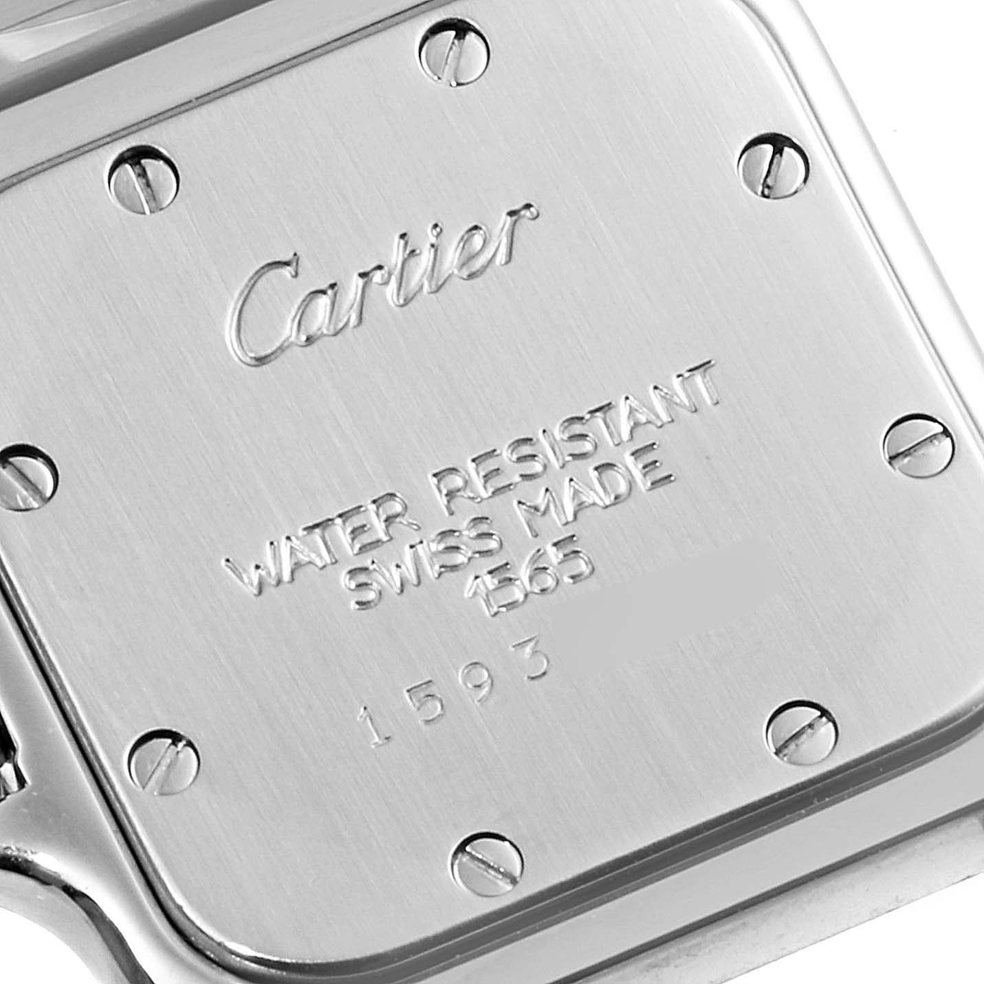 This image shows the case back of a Cartier Santos W20056D6 Women's Stainless Steel Silver Dial W20056D6 Women's Stainless Steel Silver Dial watch, displaying engravings and visible screws.