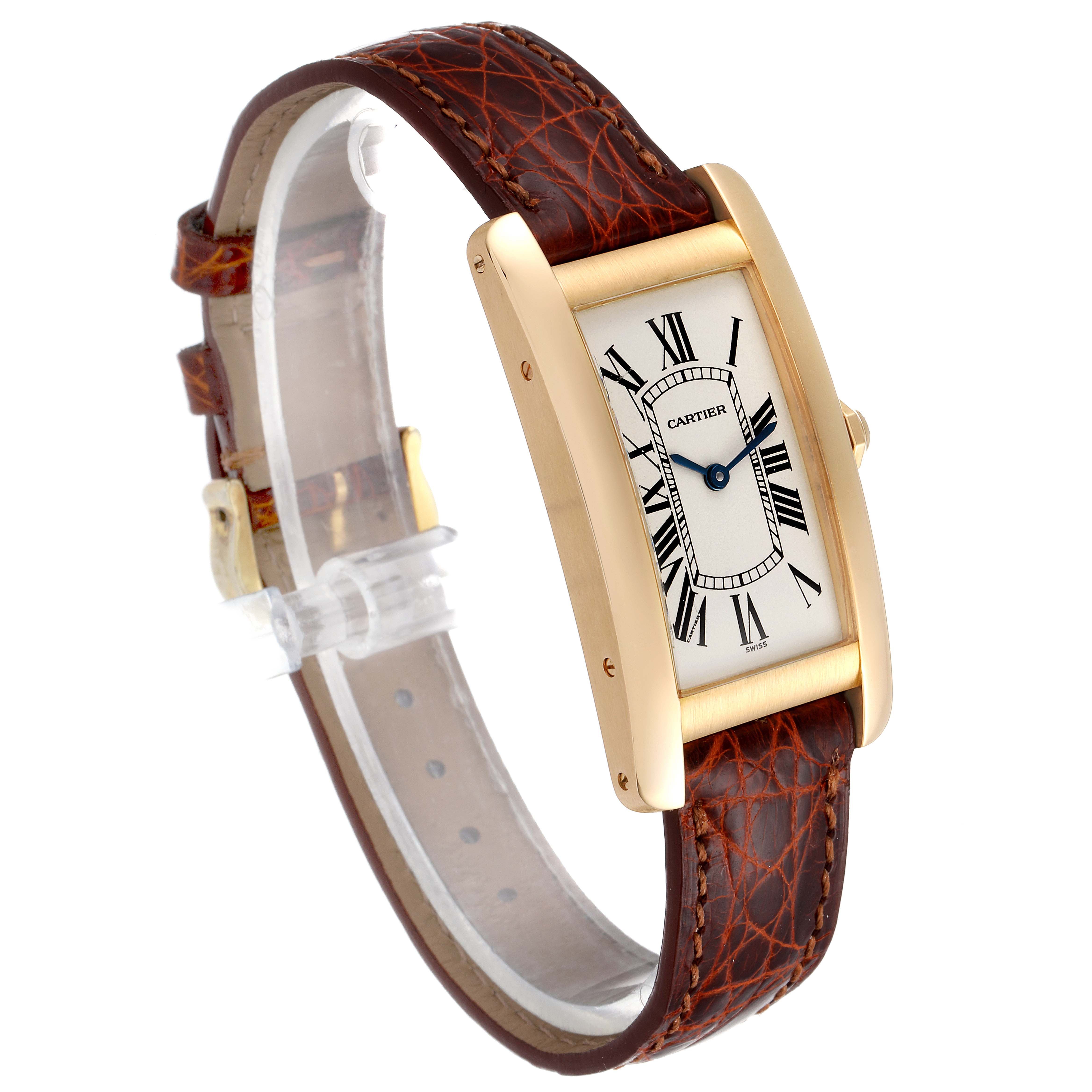 The image shows a Cartier Tank Americaine W2601456 Men's Yellow Gold Silver Dial W2601456 Men's Yellow Gold Silver Dial watch at an angled, side perspective highlighting the face, case, and leather strap.