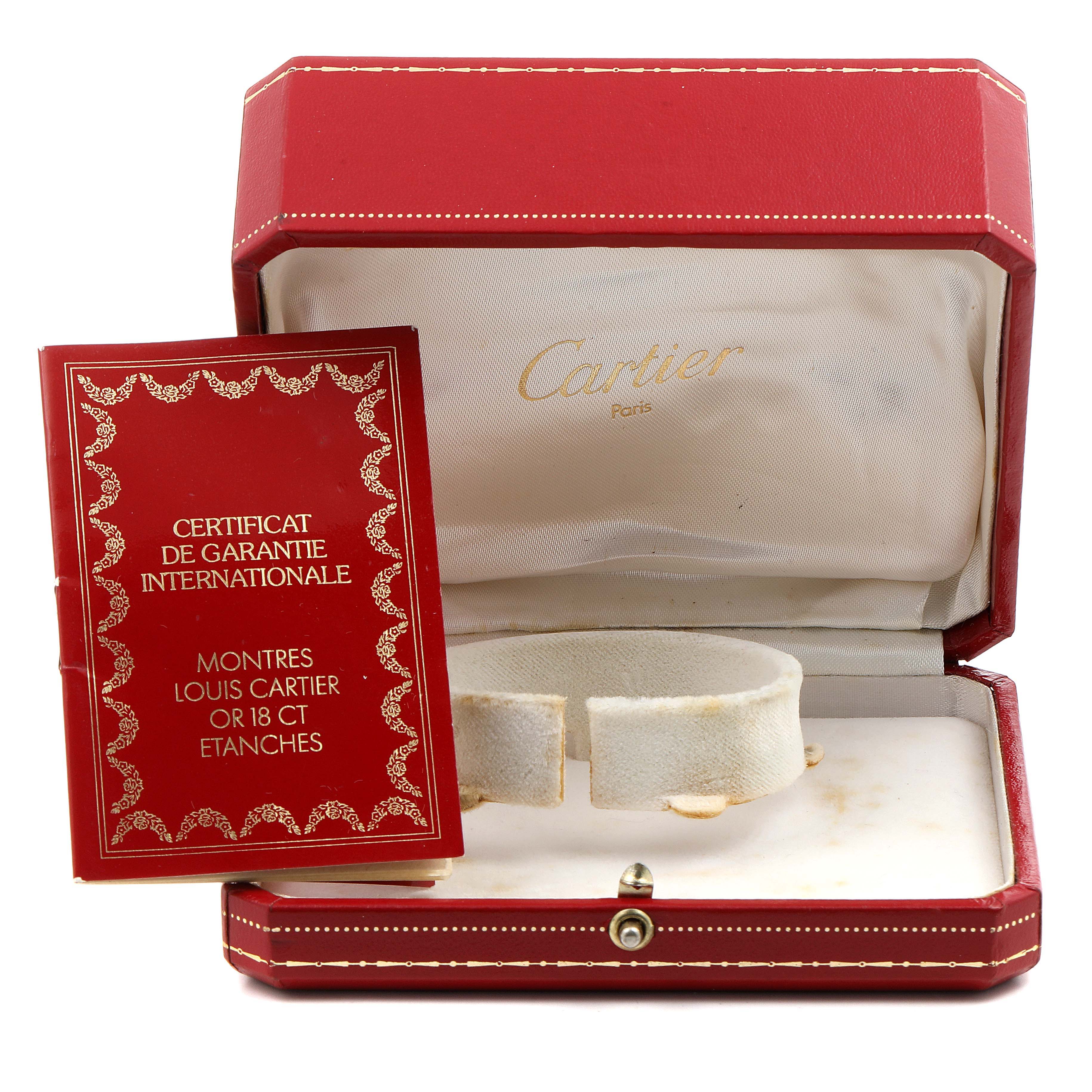 The image displays the Cartier Tank Américaine's red case and a guarantee certificate, shown from a front angle.