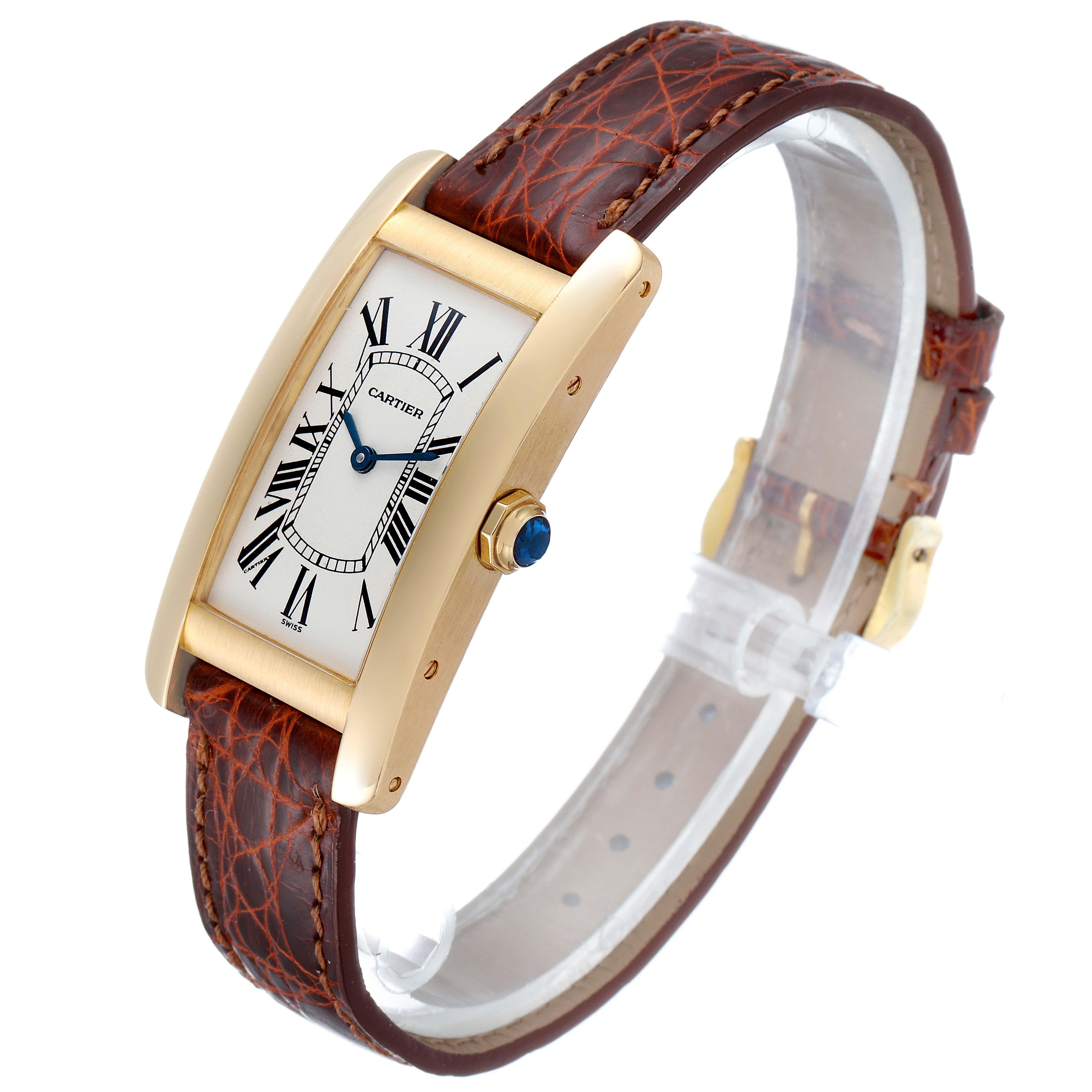 The image shows a Cartier Tank Americaine W2601456 Men's Yellow Gold Silver Dial W2601456 Men's Yellow Gold Silver Dial watch at a three-quarter angle, highlighting the face, leather strap, and side crown.