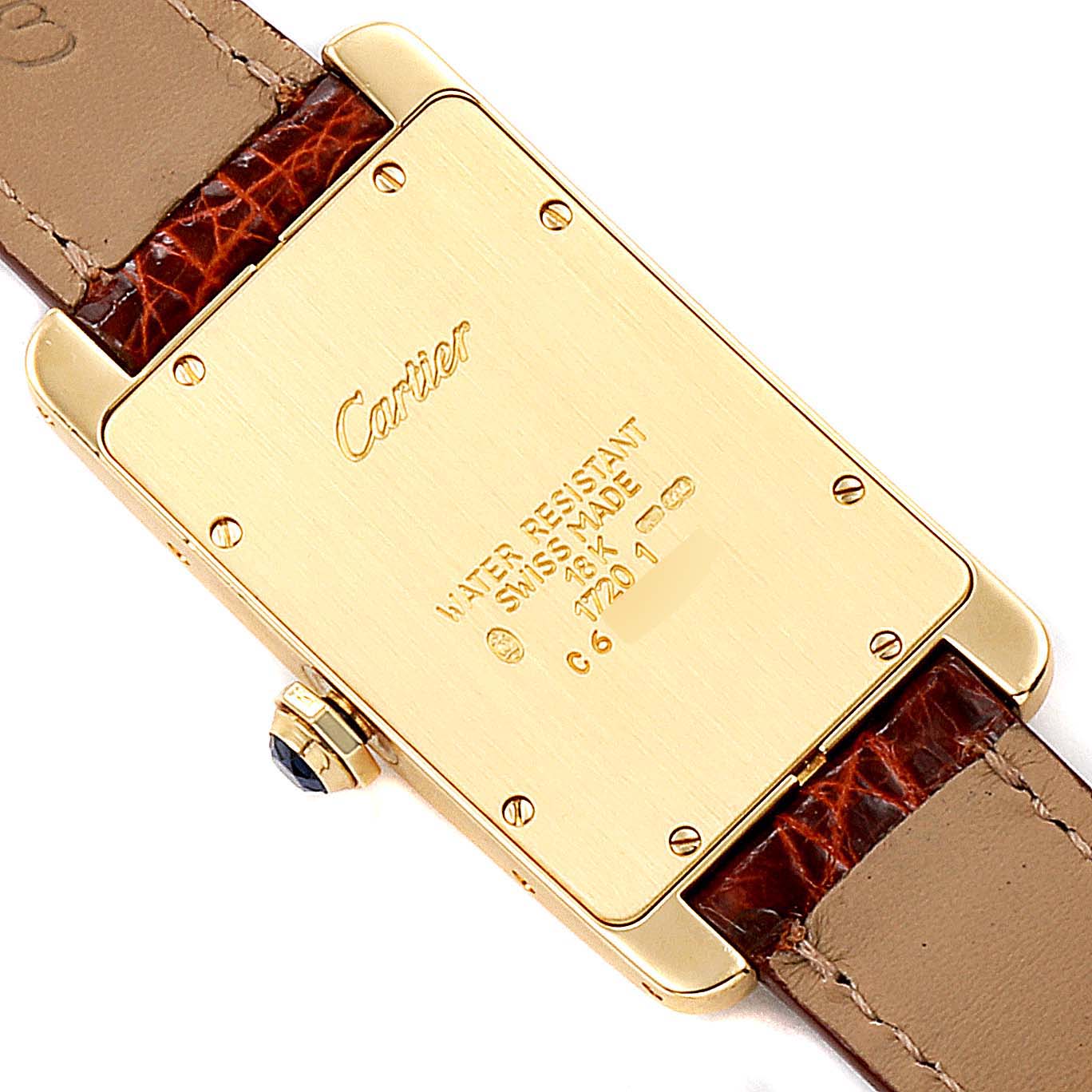 This image shows the back of a Cartier Tank Americaine W2601456 Men's Yellow Gold Silver Dial W2601456 Men's Yellow Gold Silver Dial watch, displaying its caseback, screws, crown, and part of the leather strap.