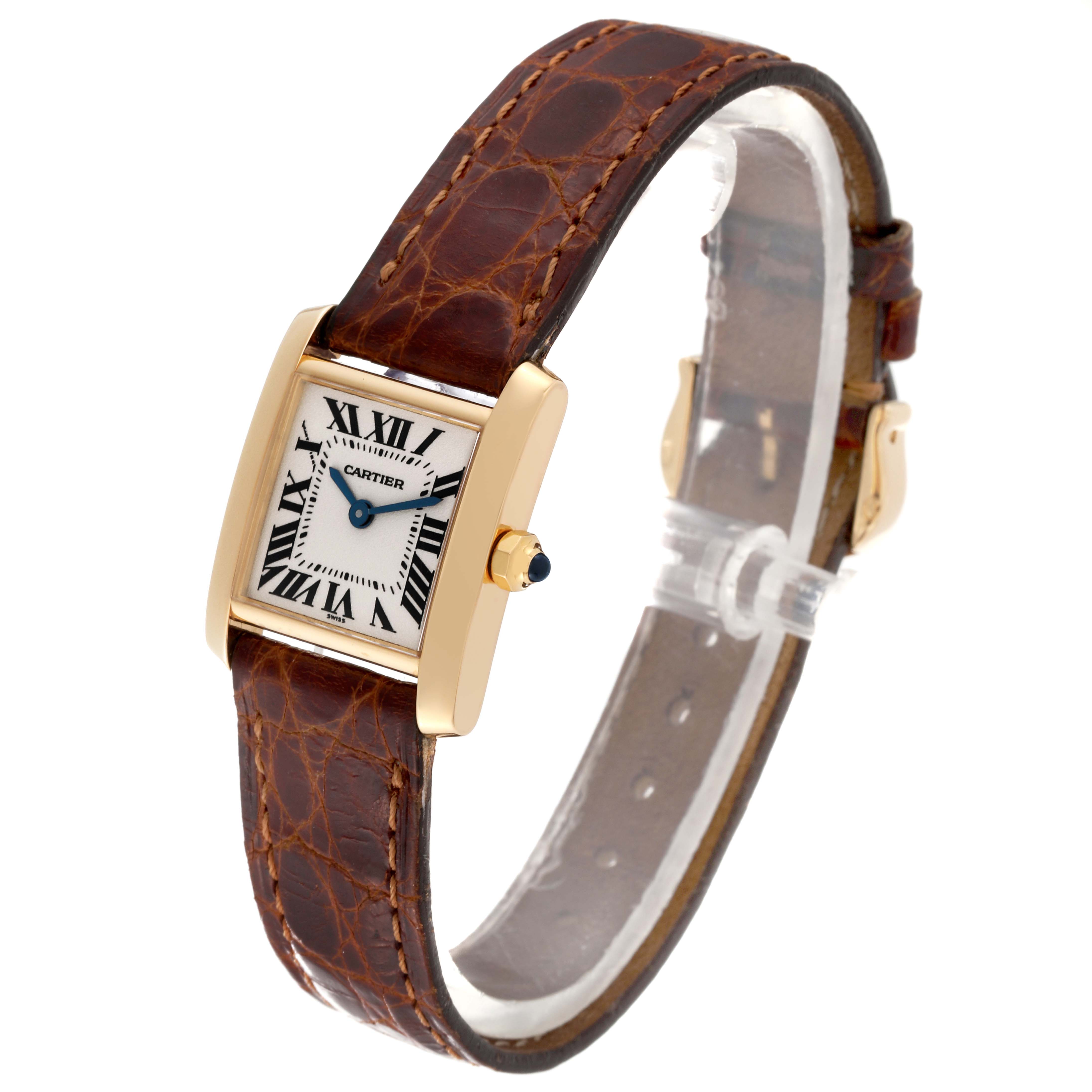 The image shows a Cartier Tank Française watch with a rectangular gold case and a brown leather strap, viewed from an angled perspective.