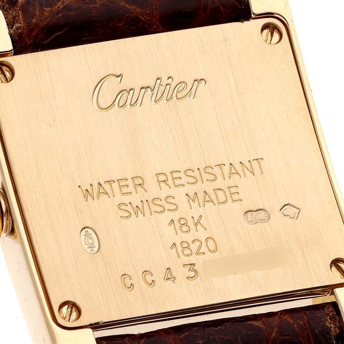 This image shows the case back of a Cartier Tank Francaise W5000256 Women's Yellow Gold Silver Dial W5000256 Women's Yellow Gold Silver Dial watch, featuring engraved details such as brand, water resistance, and material.