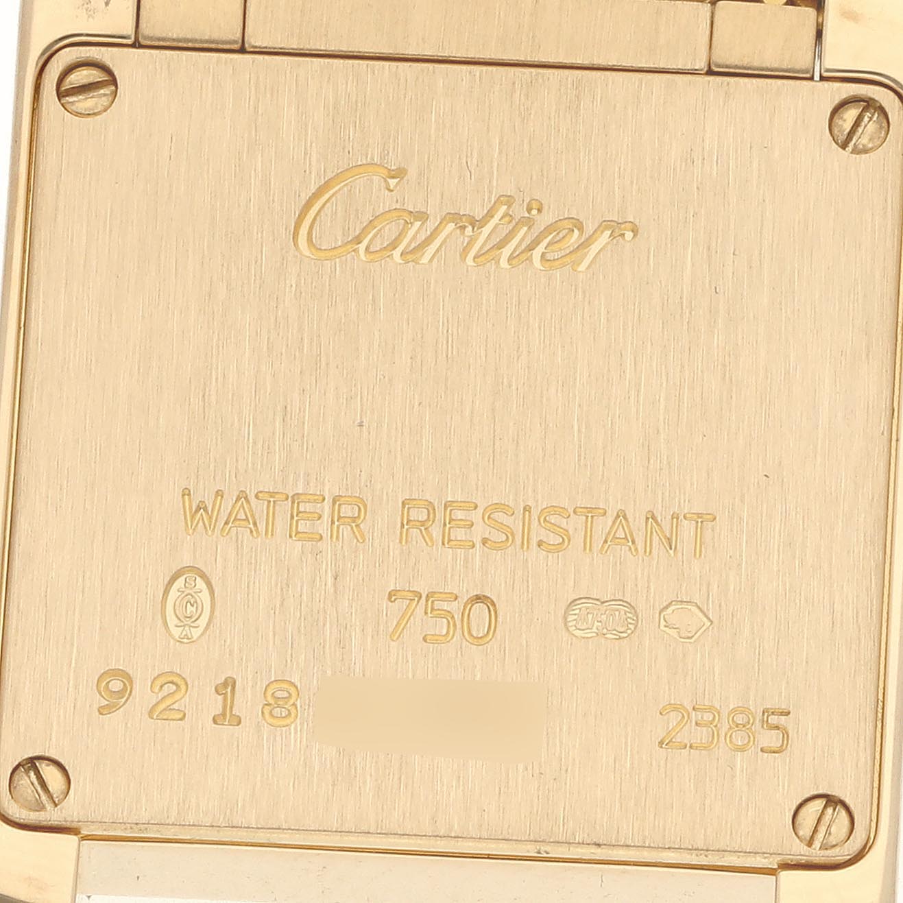 The image shows the back case of the Cartier Tank Francaise WE1001R8 Women's Yellow Gold Silver Dial WE1001R8 Women's Yellow Gold Silver Dial watch, engraved with brand details and serial numbers.