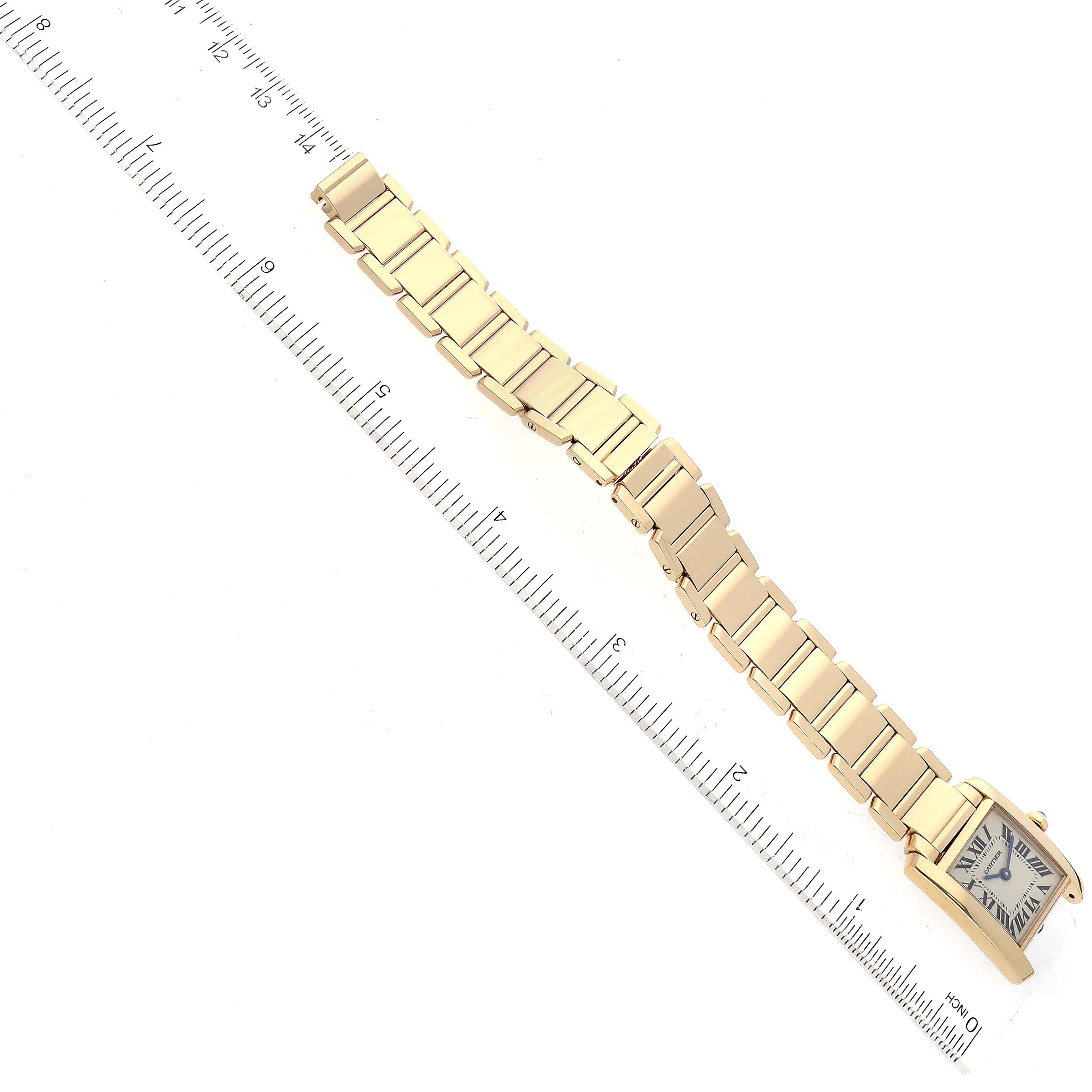 The image shows a Cartier Tank Française watch laid out flat next to a ruler, highlighting its bracelet.