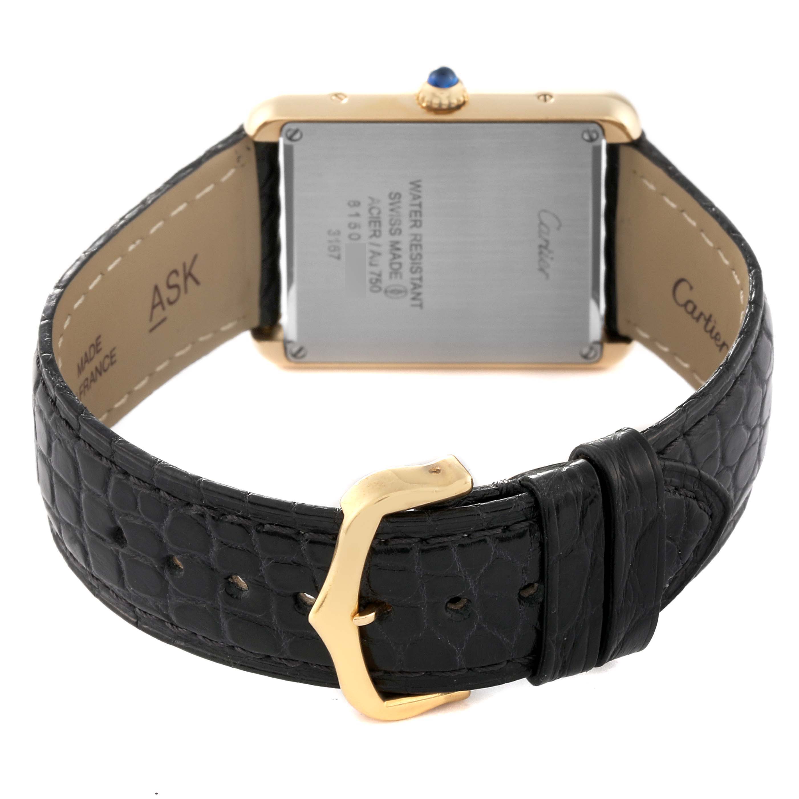 The image shows the back of a Cartier Tank Solo W5200004 Men
s Steel and Gold (two tone) Silver Dial W5200004 Men
s Steel and Gold (two tone) Silver Dial watch, displaying its case back, crown, and black leather strap with a gold buckle.