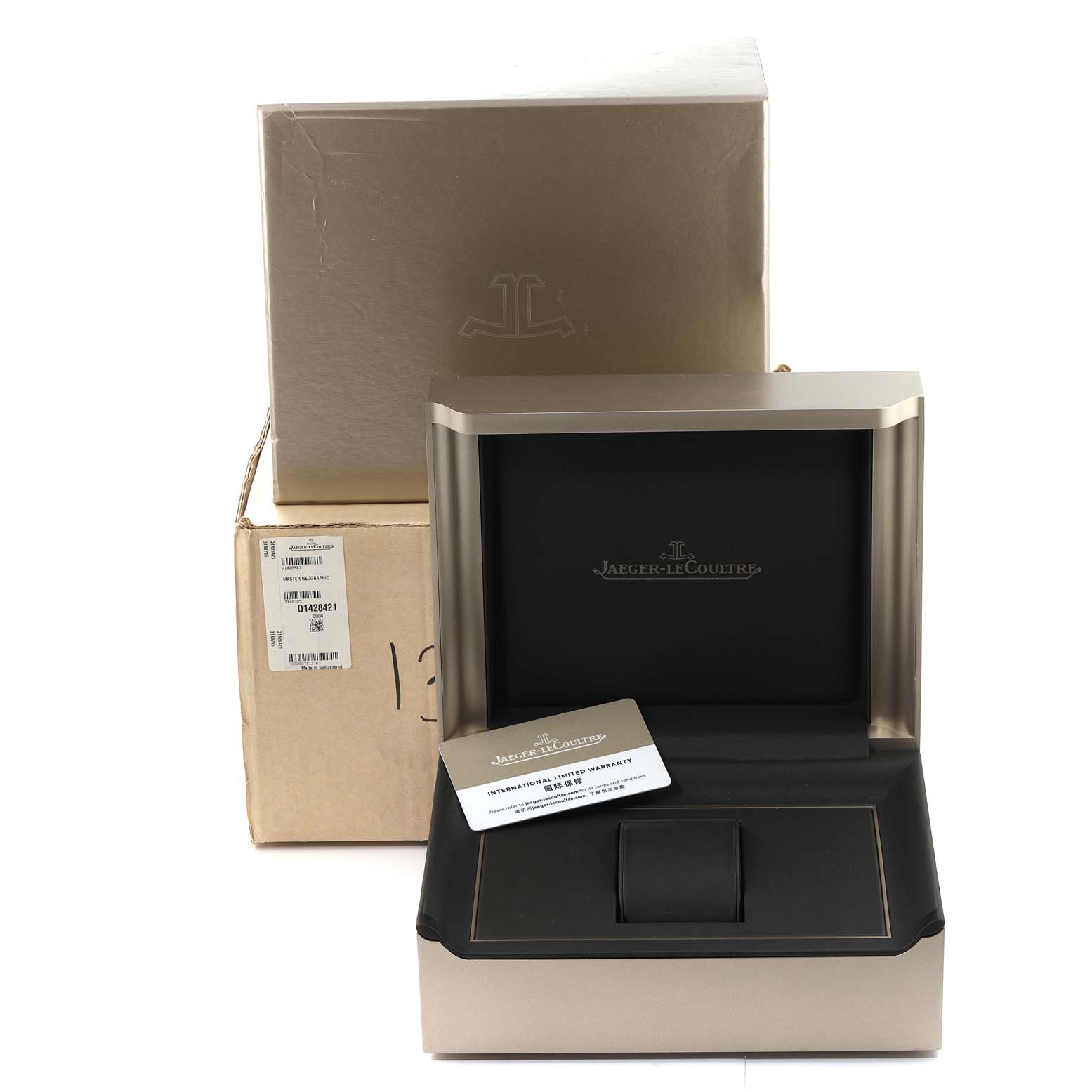 The image shows the packaging and case for a Jaeger-LeCoultre Master model watch, with the case lid open and a warranty card visible.