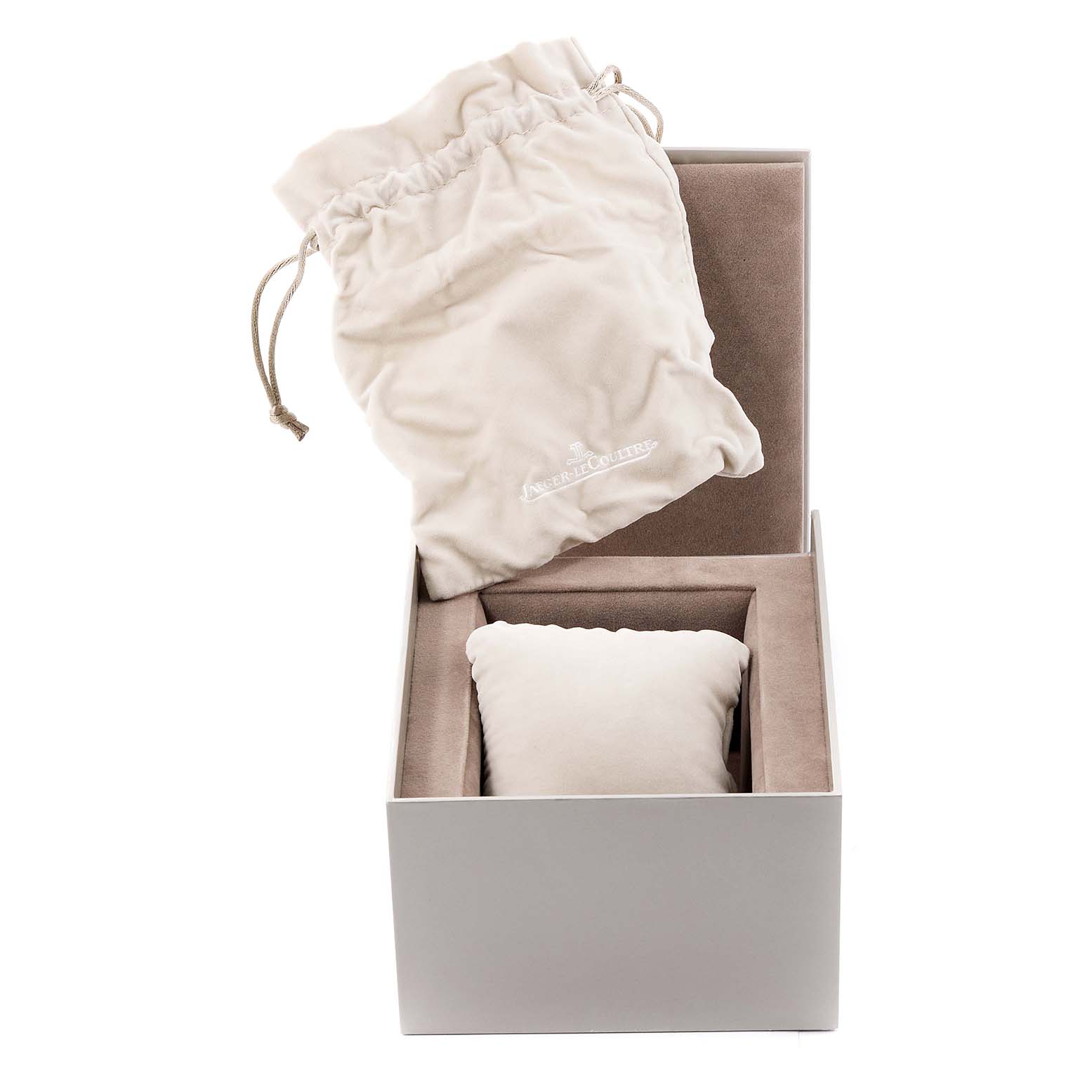 The image shows a Jaeger-LeCoultre Reverso watch box, including a drawstring pouch and a cushioned compartment for the watch.