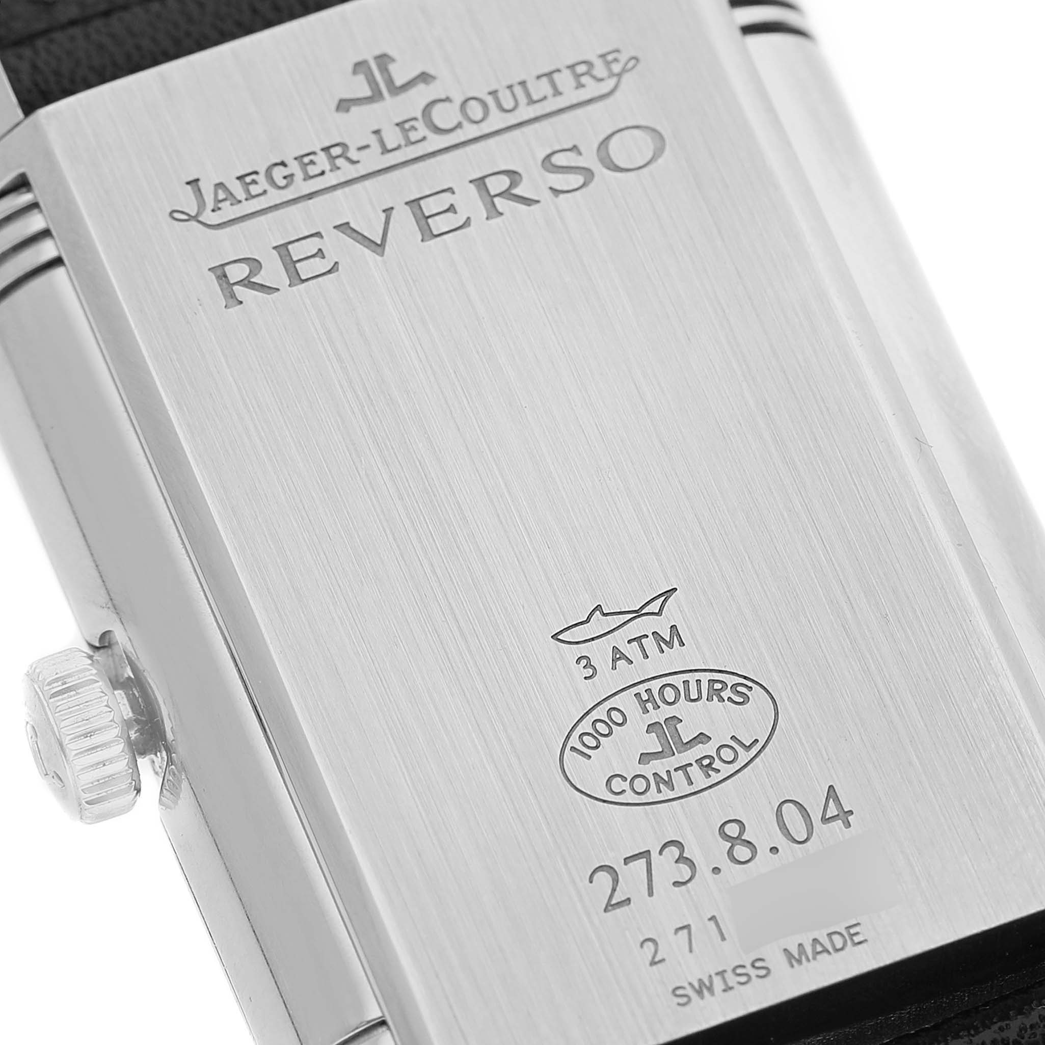 The image shows the Jaeger-LeCoultre Reverso watch's backside, highlighting the brand, model name, and durability specifications.