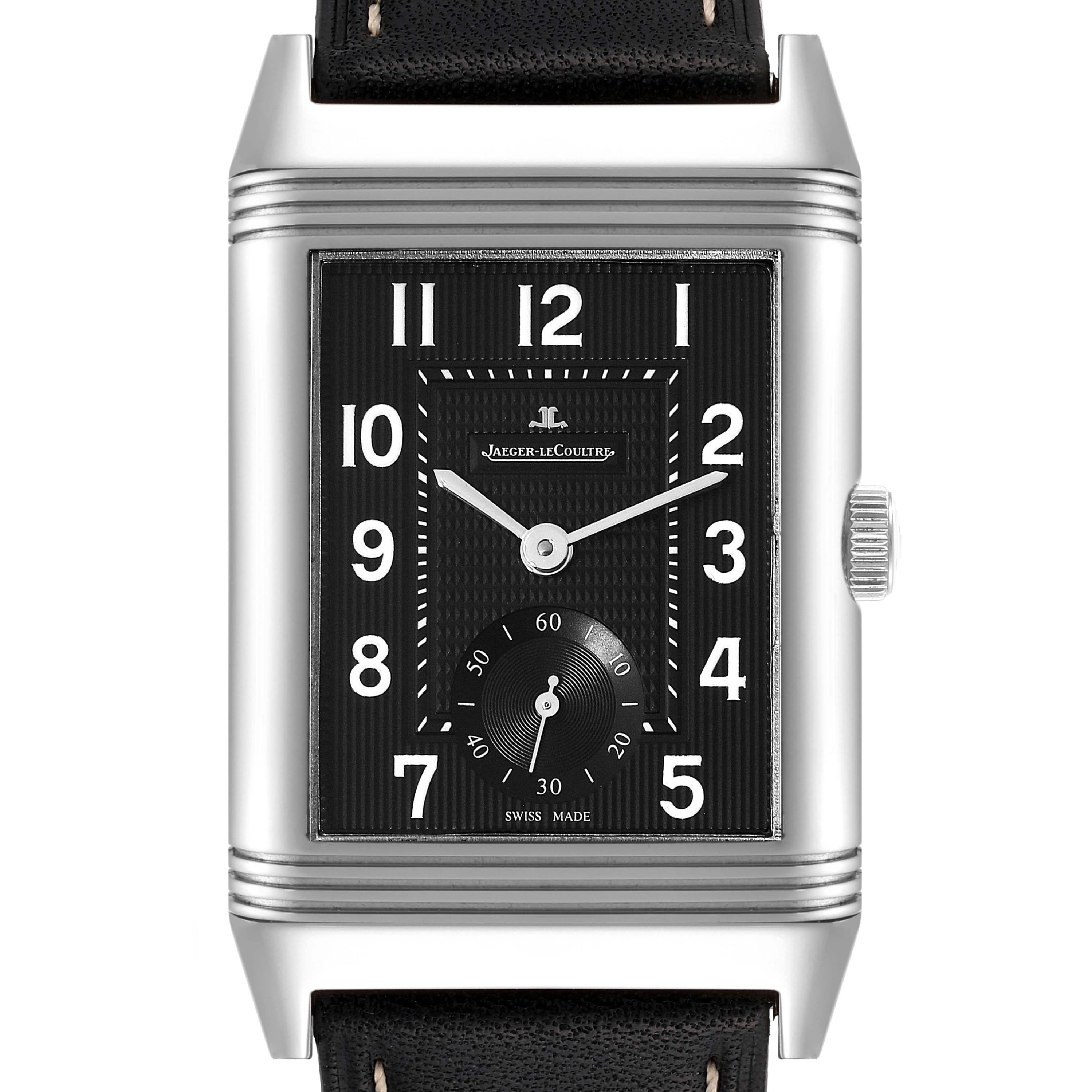 The image shows a front view of a Jaeger-LeCoultre Reverso watch featuring a black dial, Arabic numerals, and a sub-dial for seconds.
