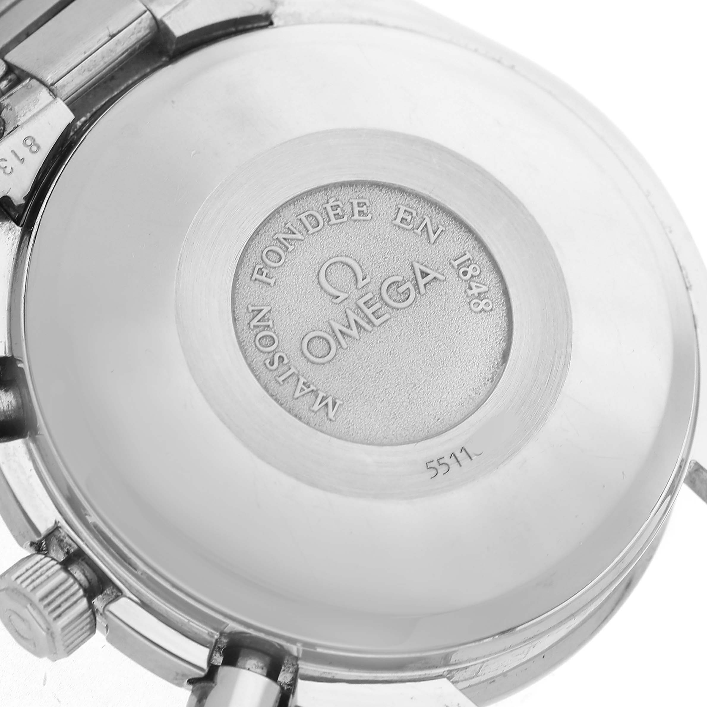 The image shows the back case of the Omega Speedmaster 3521.80.00 Men's Stainless Steel Blue Dial watch, featuring branding and engraved text.