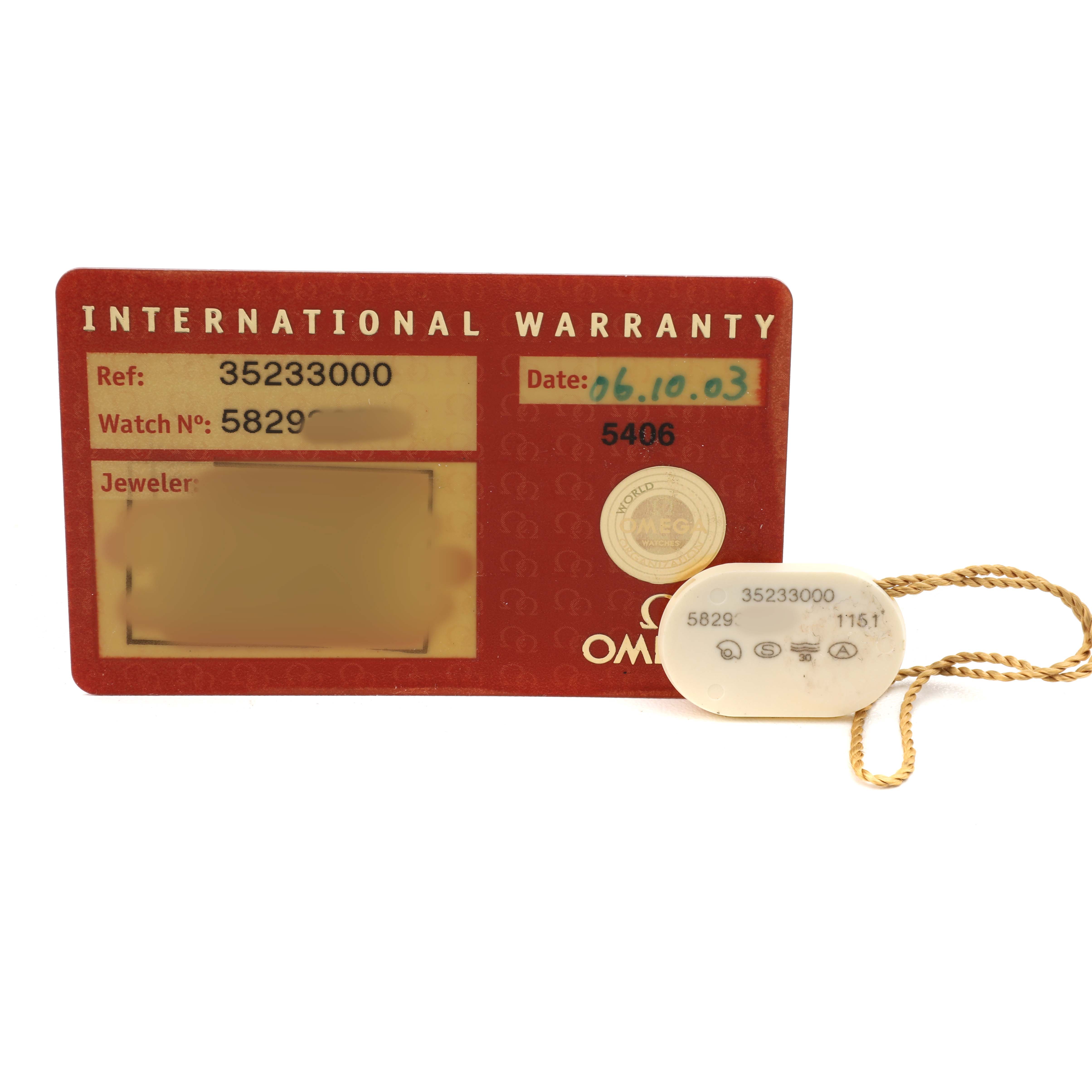 The image shows an Omega Speedmaster 3523.30.00 Men's Stainless Steel Silver Dial International Warranty card and a tag with reference and serial numbers.