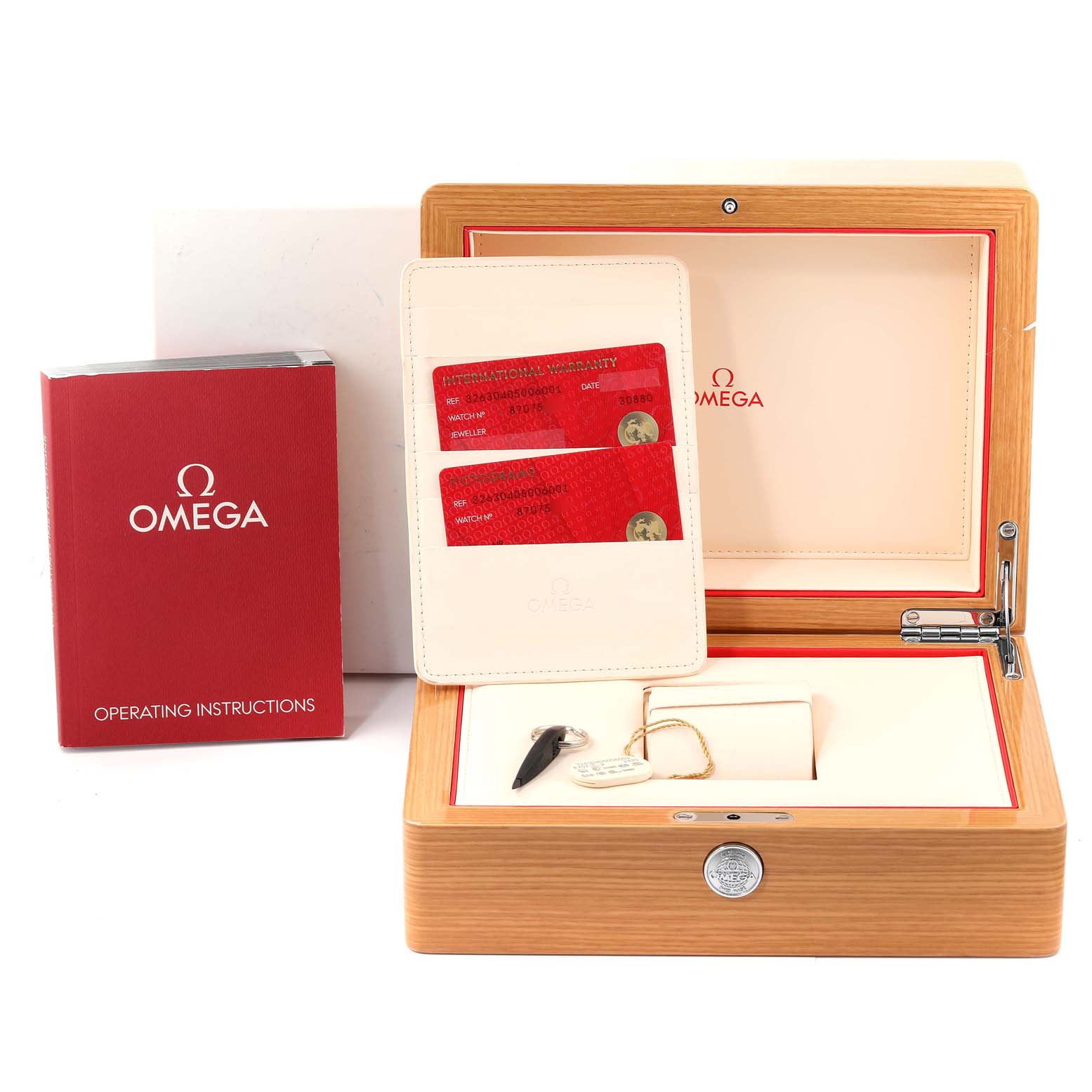 The image shows an Omega Speedmaster 326.30.40.50.06.001 Men
s Stainless Steel Grey Dial 326.30.40.50.06.001 Men
s Stainless Steel Grey Dial watch box, instruction manual, warranty cards, and accessories.