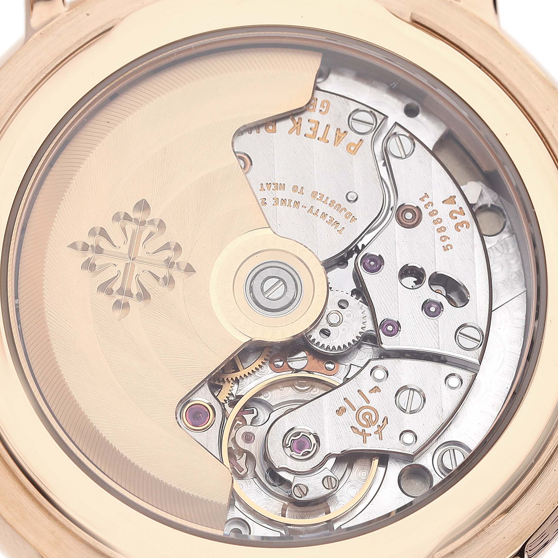 The image shows the back view of a Patek Philippe Calatrava 5153R-001 Men's Rose Gold Silver Dial 5153R-001 Men's Rose Gold Silver Dial watch, highlighting its intricate mechanical movement through a transparent case back.
