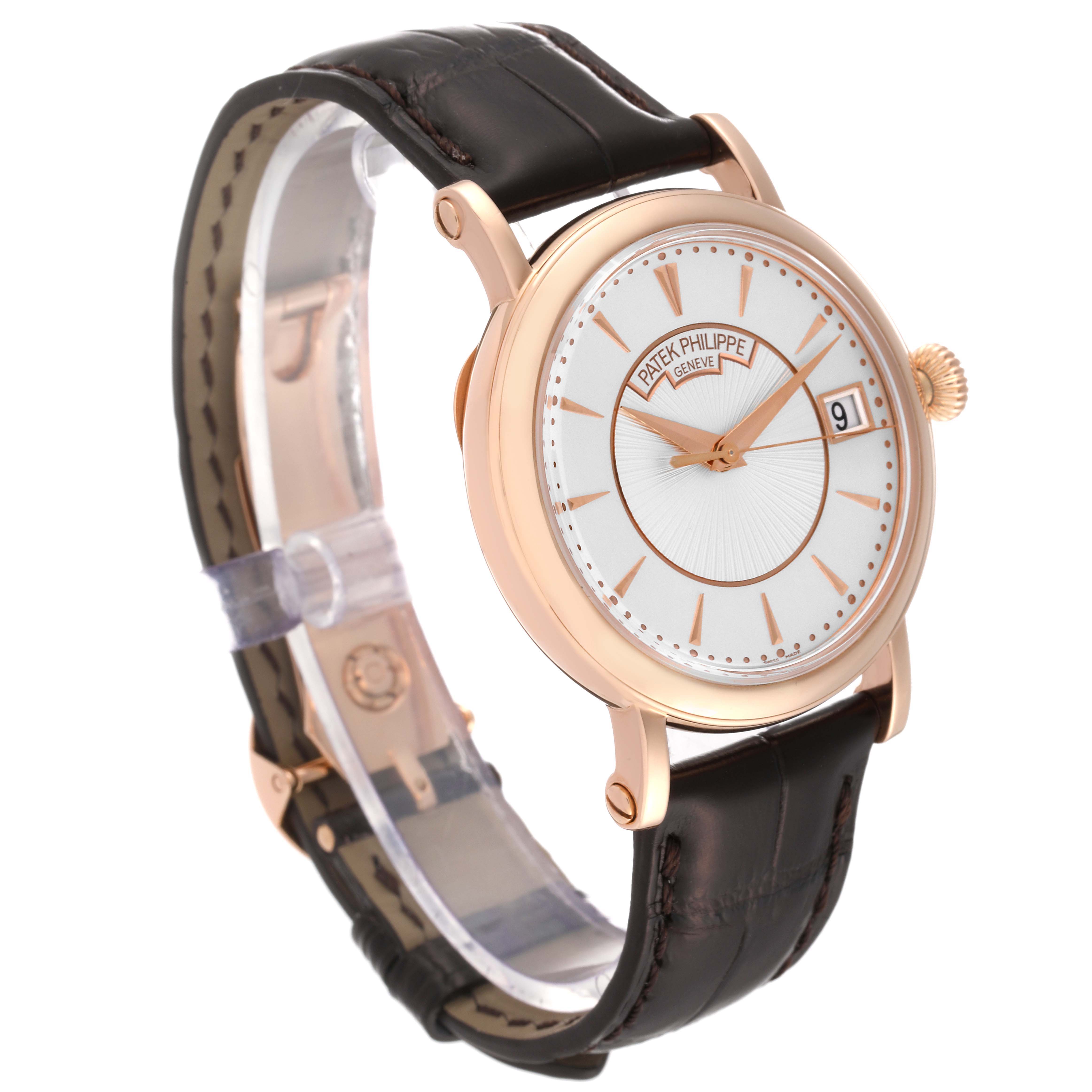 This image shows a Patek Philippe Calatrava 5153R-001 Men's Rose Gold Silver Dial 5153R-001 Men's Rose Gold Silver Dial watch at a three-quarter angle, highlighting its dial, case, and leather strap.