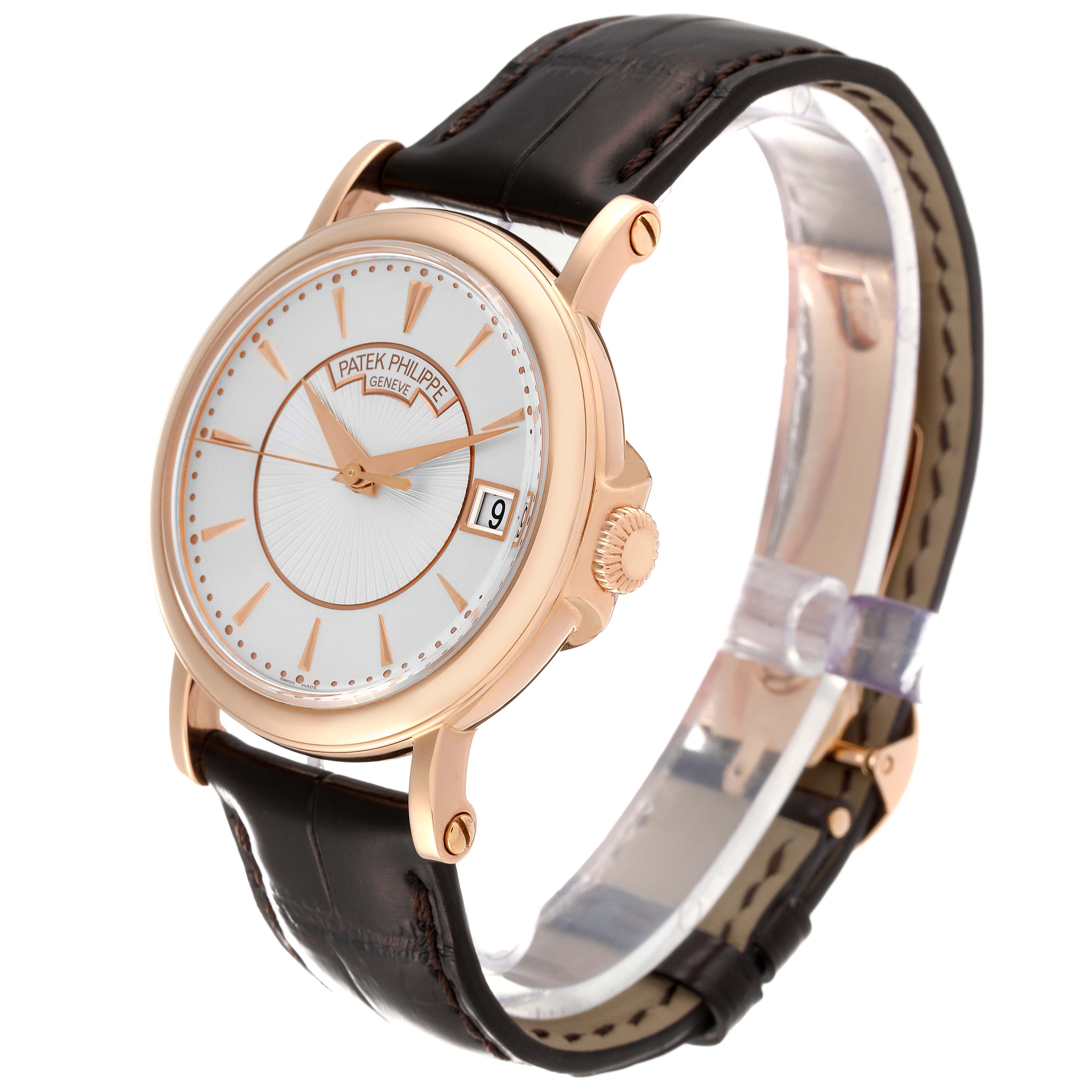 This image shows a Patek Philippe Calatrava 5153R-001 Men's Rose Gold Silver Dial 5153R-001 Men's Rose Gold Silver Dial watch at a slight angle, highlighting the dial, crown, and leather strap.