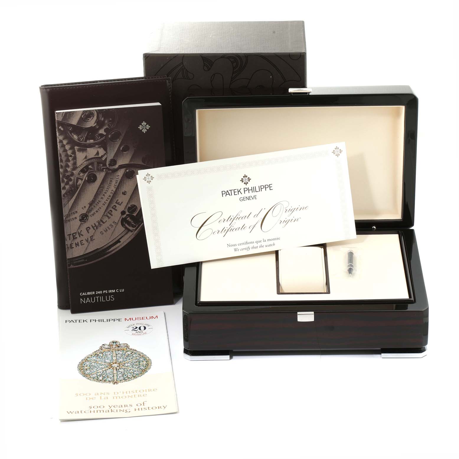 The image shows a Patek Philippe Calatrava 5057G-010 Men's White Gold Grey Dial watch box set with a certificate, booklet, and accessories from a frontal angle.
