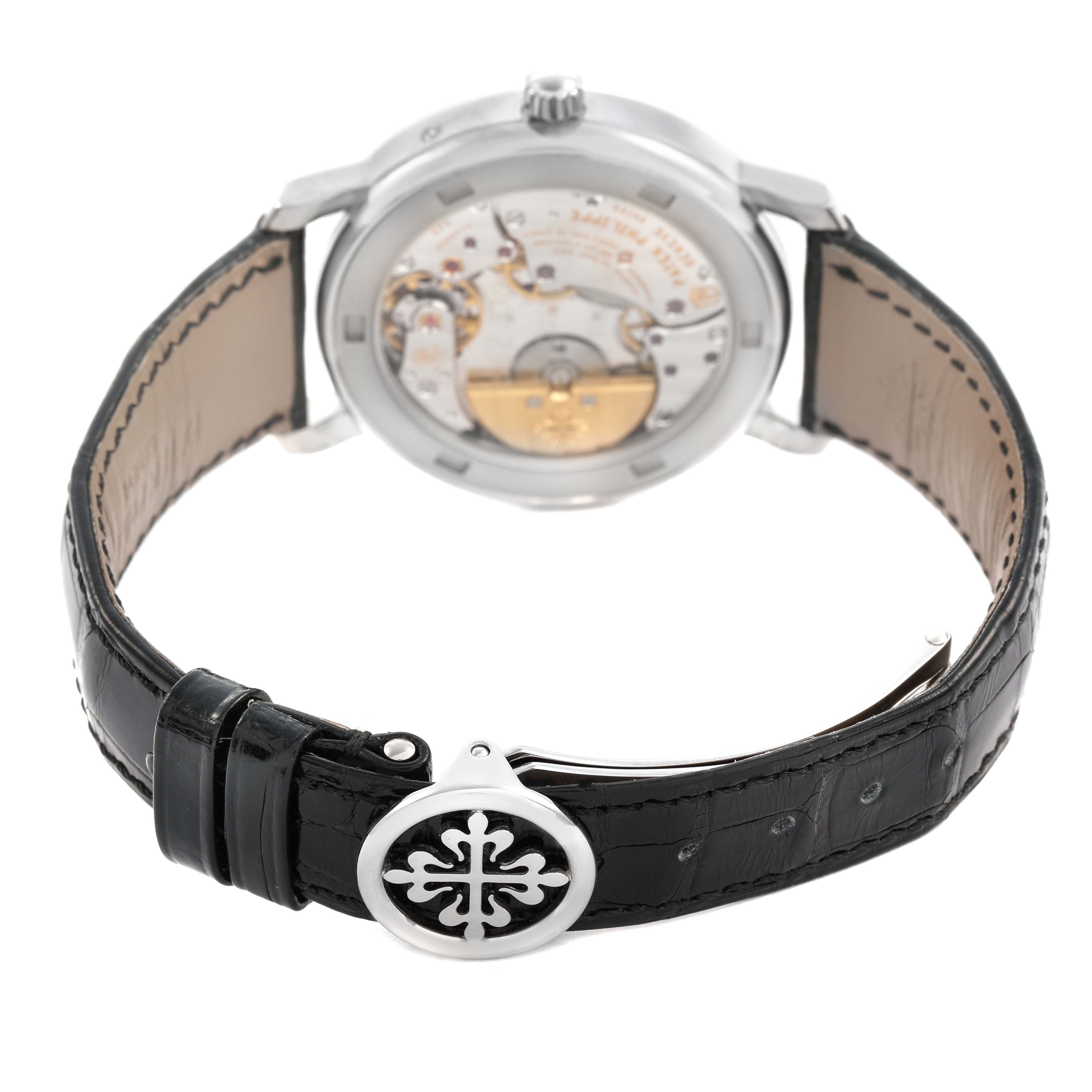 This image shows the back of a Patek Philippe Calatrava 5057G-010 Men's White Gold Grey Dial watch, highlighting the movement and black leather strap with the clasp.