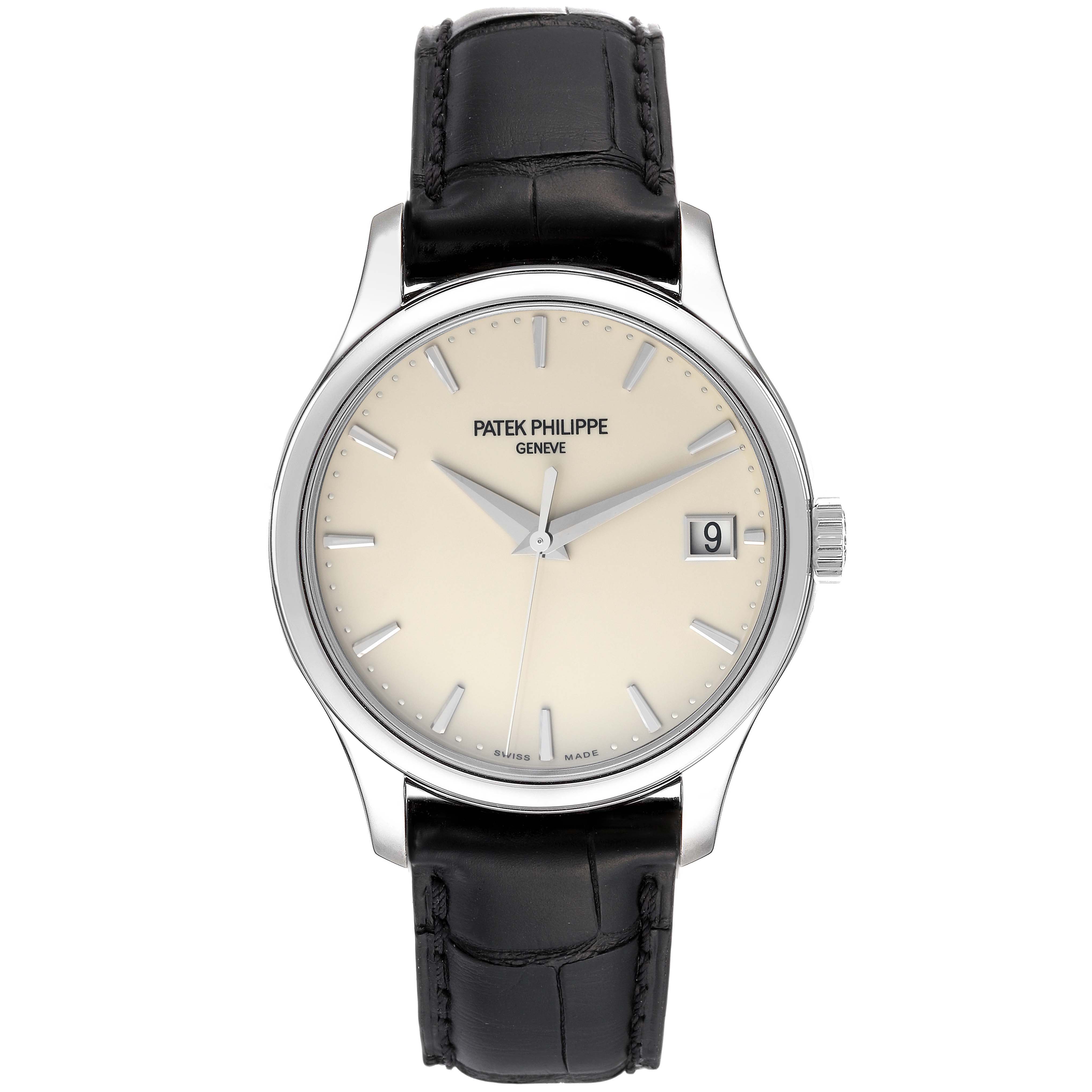 The image shows a front view of a Patek Philippe Calatrava 5227G-001 Men's White Gold Beige Dial 5227G-001 Men's White Gold Beige Dial watch with a beige dial, black leather strap, and date window.