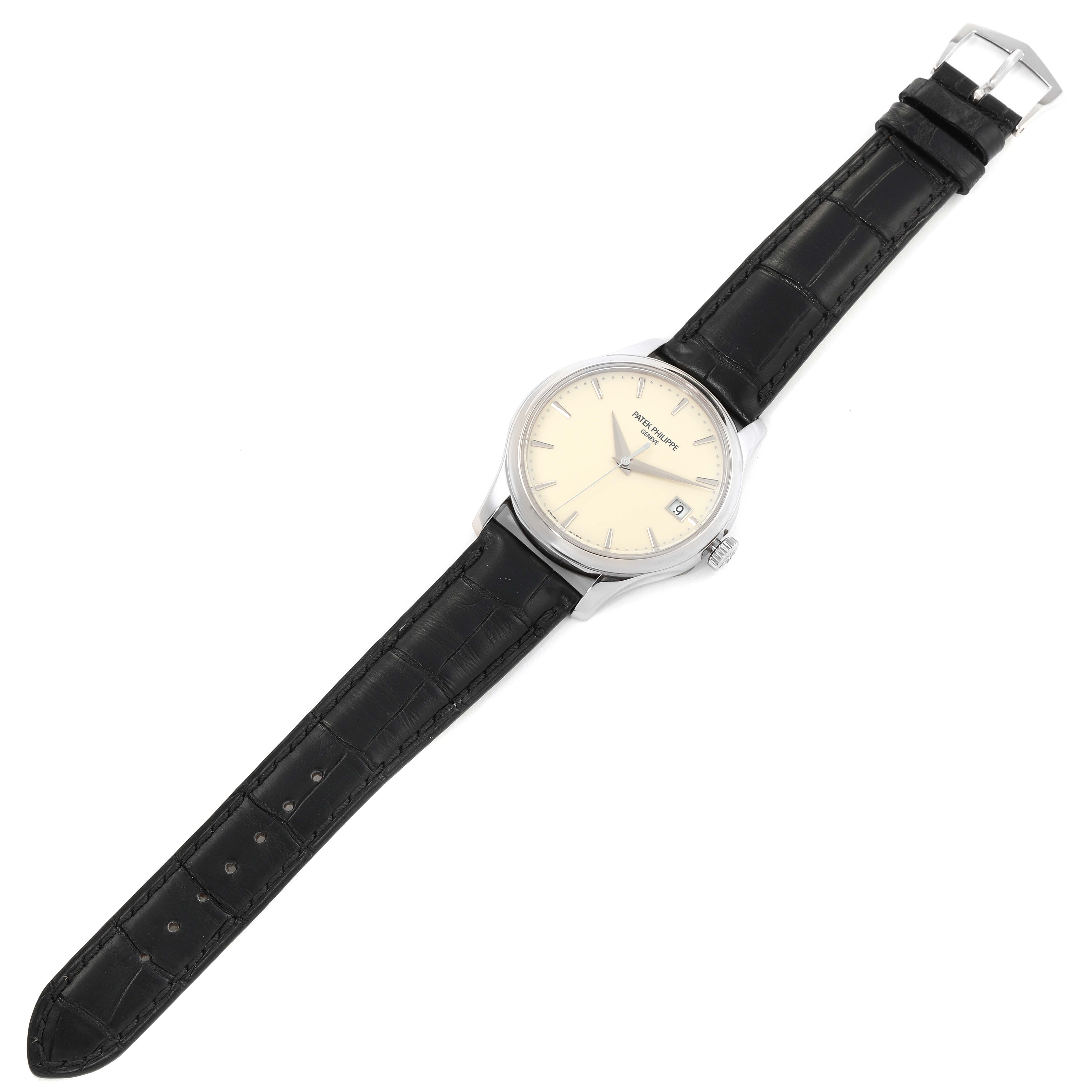 The image shows a top-down view of a Patek Philippe Calatrava 5227G-001 Men's White Gold Beige Dial 5227G-001 Men's White Gold Beige Dial watch, displaying the face, band, and buckle.