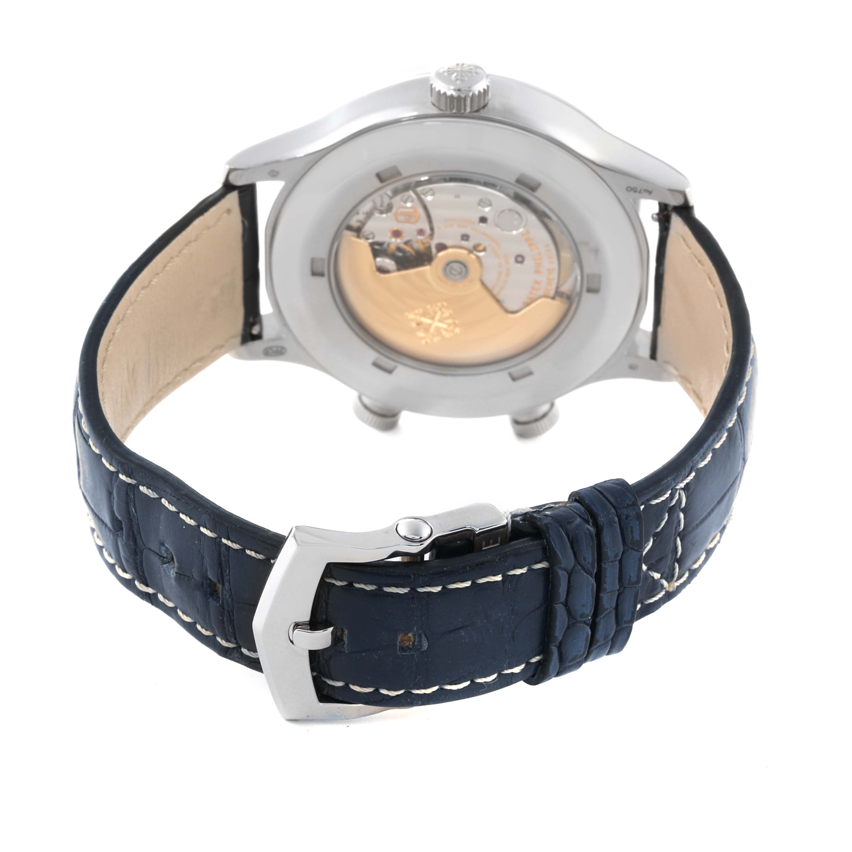 The image shows the back view of a Patek Philippe Calatrava 5524G-001 Men's White Gold Black Dial 5524G-001 Men's White Gold Black Dial watch, highlighting the movement and the blue leather strap with a buckle.
