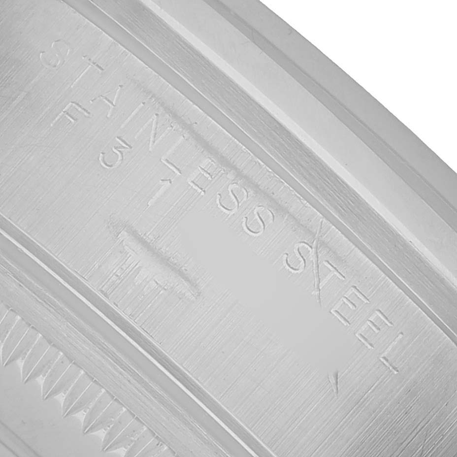 The image shows a macro view of the rim with engravings on the stainless steel casing of a Rolex Air-King 14000 Men's Stainless Steel Blue Dial.