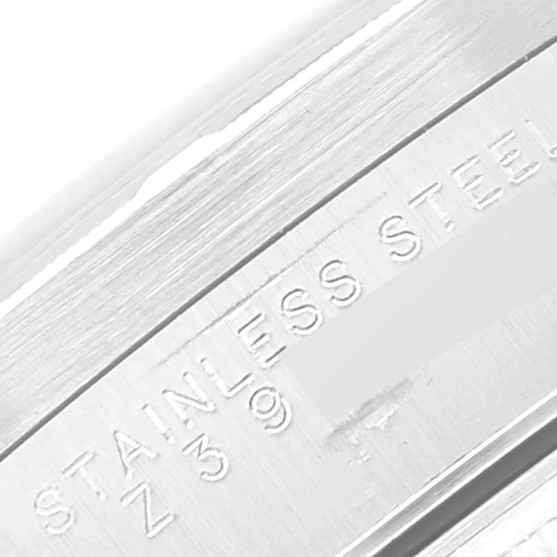 The image shows a close-up of the Rolex Air-King 14010M Men's Stainless Steel Silver Dial 14010M Men's Stainless Steel Silver Dial watch's stainless steel case side, displaying engraved text.