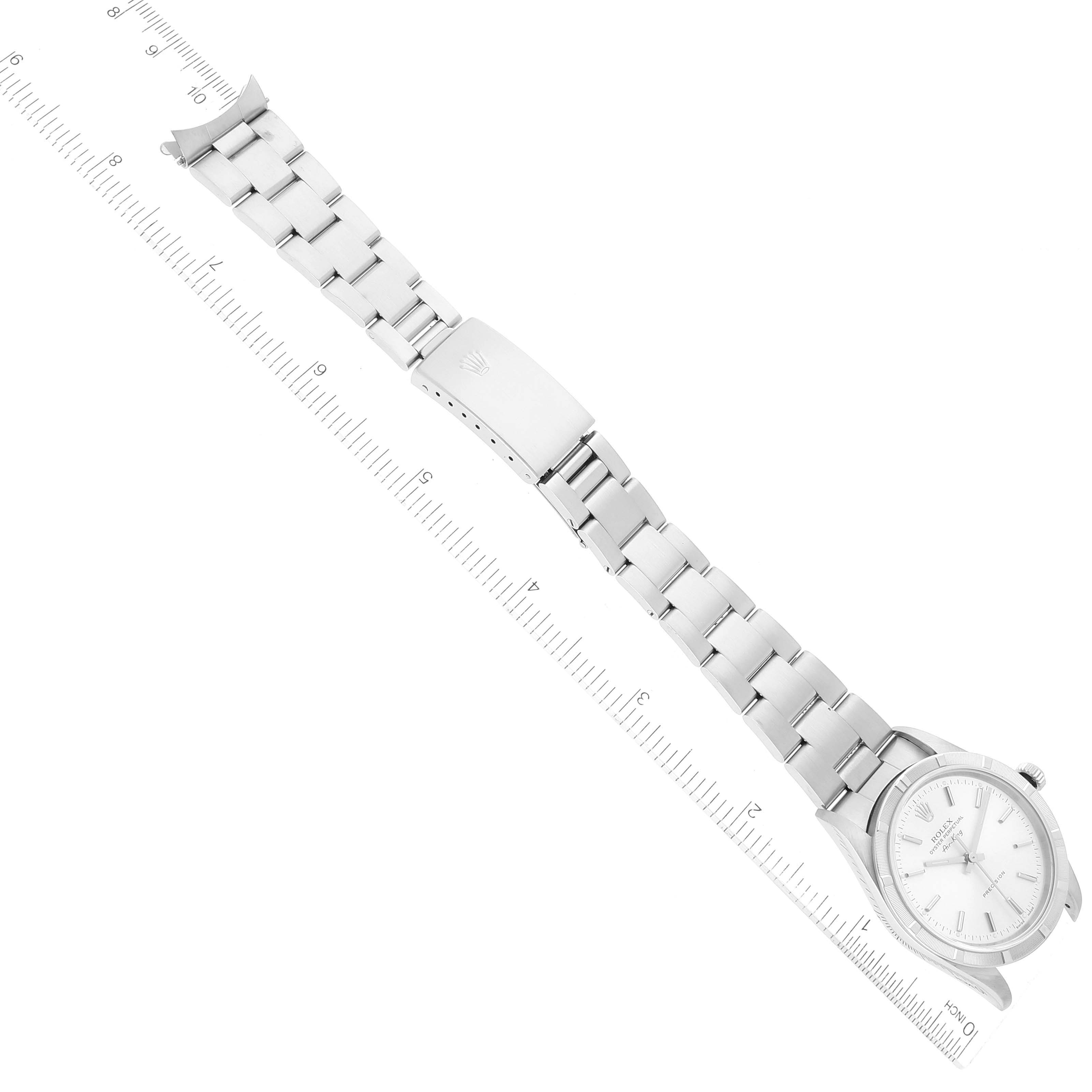The Rolex Air-King 14010M Men's Stainless Steel Silver Dial 14010M Men's Stainless Steel Silver Dial watch is shown diagonally with the full bracelet and clasp visible, alongside a ruler for scale.