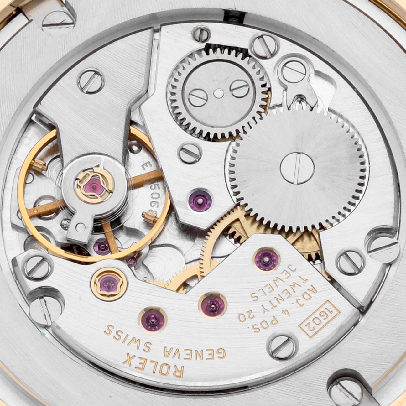 This is a close-up of the internal movement components of a Rolex Cellini 5115/8 Men's Yellow Gold Beige Dial 5115/8 Men's Yellow Gold Beige Dial watch, showing gears, screws, and jewels.