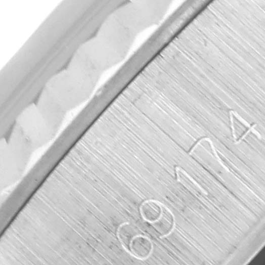 The image shows a close-up of the case edge and serial number on a Rolex Date 69174 Women's Stainless Steel Silver Dial 69174 Women's Stainless Steel Silver Dial model watch.